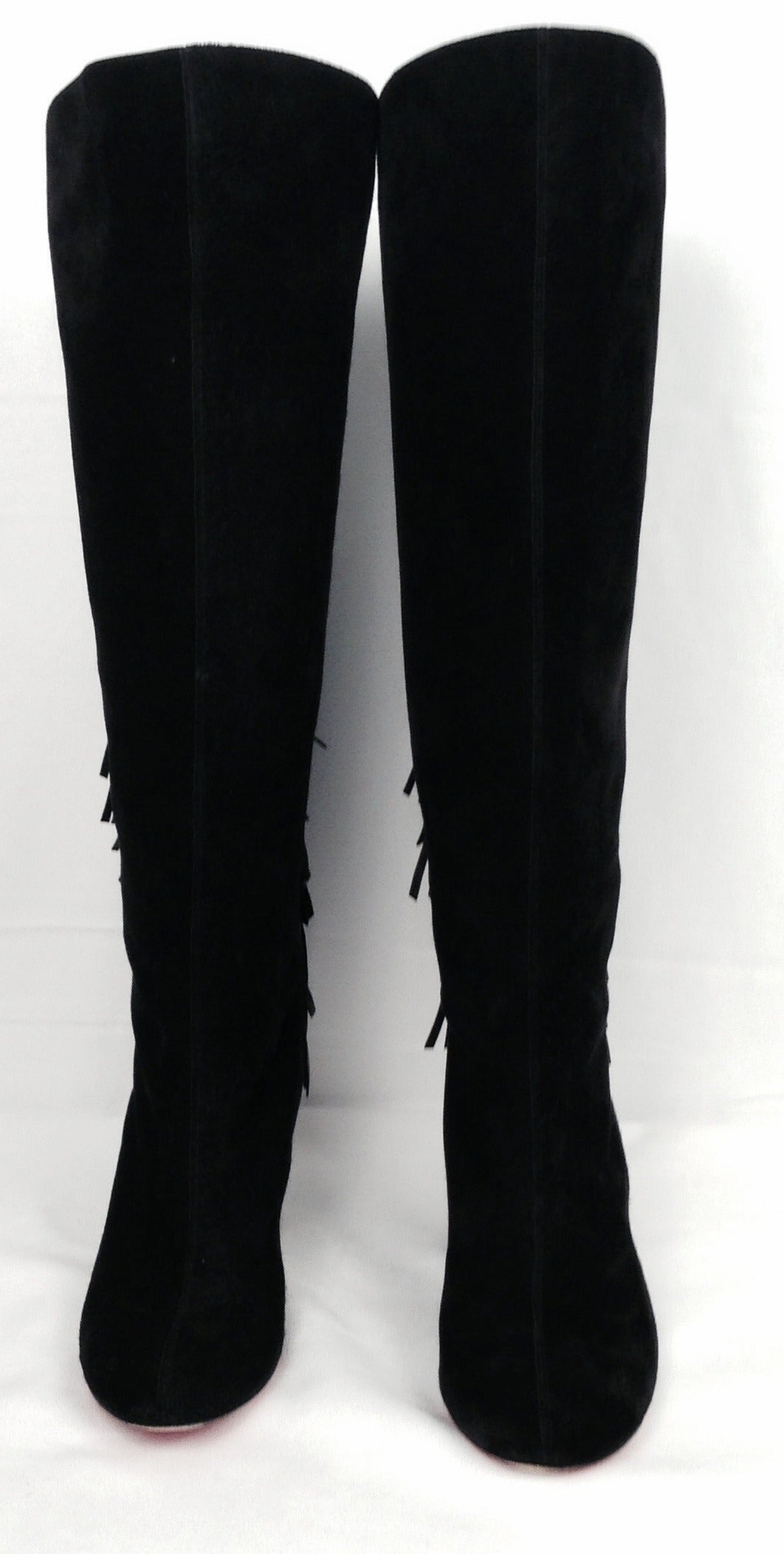 Christian Louboutin strikes again in these eye-catching black suede knee boots with wedge heel!  Boots feature luxurious 