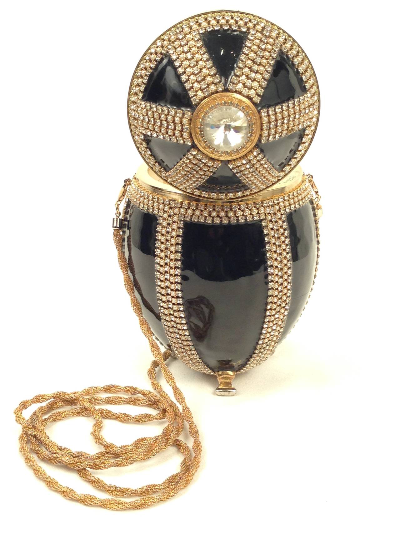 Cause a stir when carrying this exotic and luxurious minaudiere!  Vivian Alexander created the ostrich egg purse in 1990 and retired it in 2007. The enameled egg purse is made using techniques learned by Carl Faberge. Each purse begins with an