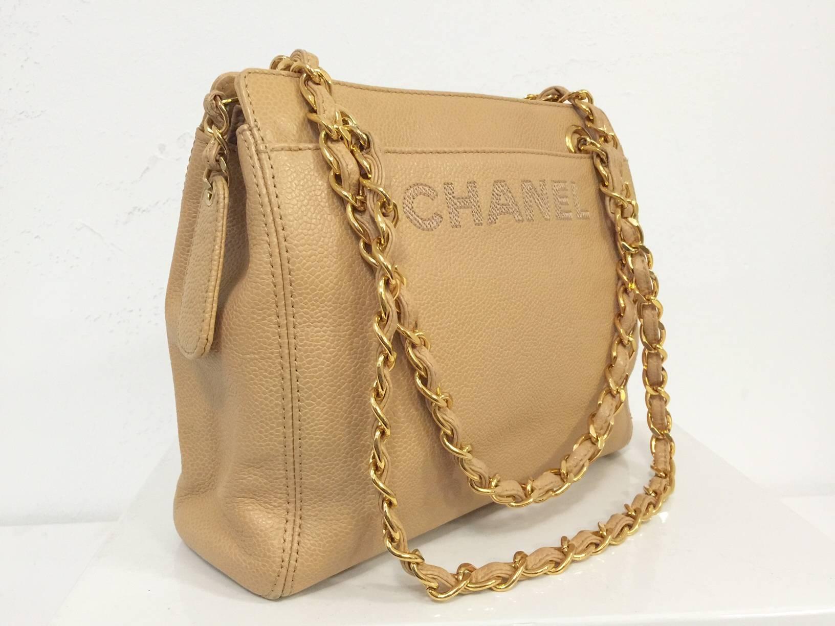 Chanel Tan Caviar Leather Shoulder Bag is a highly desired bag from one of fashion's most widely recognized icons!  Features house signature tan caviar leather, gold tone hardware,and  double leather woven chain straps.  Two open  compartments offer