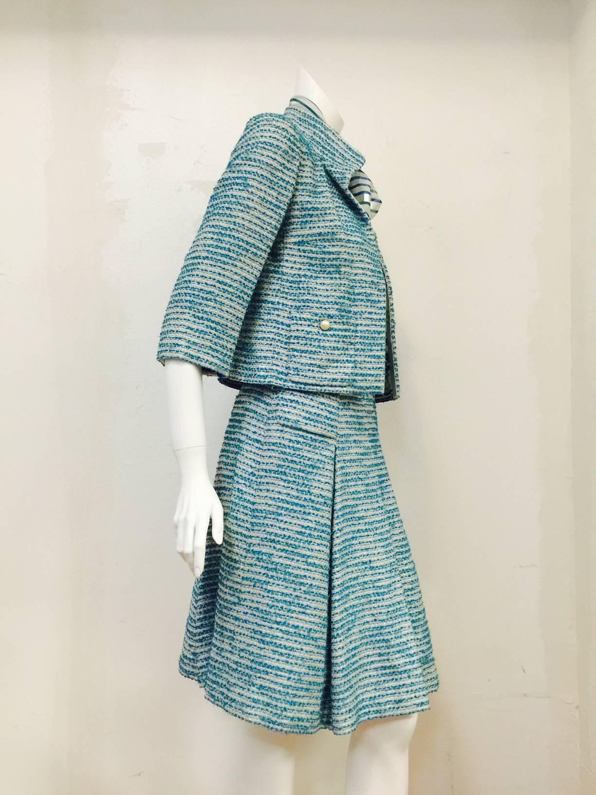 Chanel Spring 2001 Teal and Metallic Silver 3-Piece Ensemble is worthy of Coco herself!  Features a luxurious tweed blend that incorporates silver metallic thread for added sparkle!  Features full, pleated skirt, jacket and complementary blouse. 