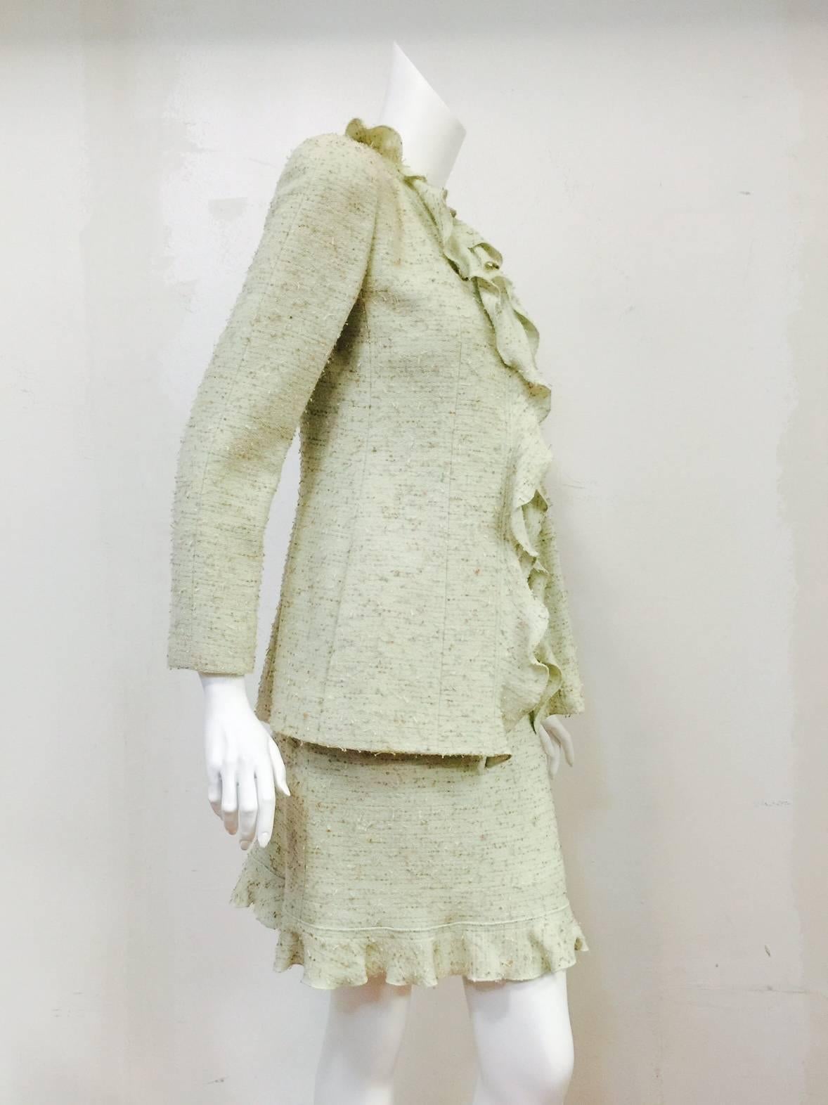 Chanel 1999 Fall Tweed Wool Blend Suit With Ruffles is a wonderful addition to any connoisseur's collection!  Not your more typical tweed creation from the house of Chanel, this suit features a soft shade of pistachio green threaded with multi color