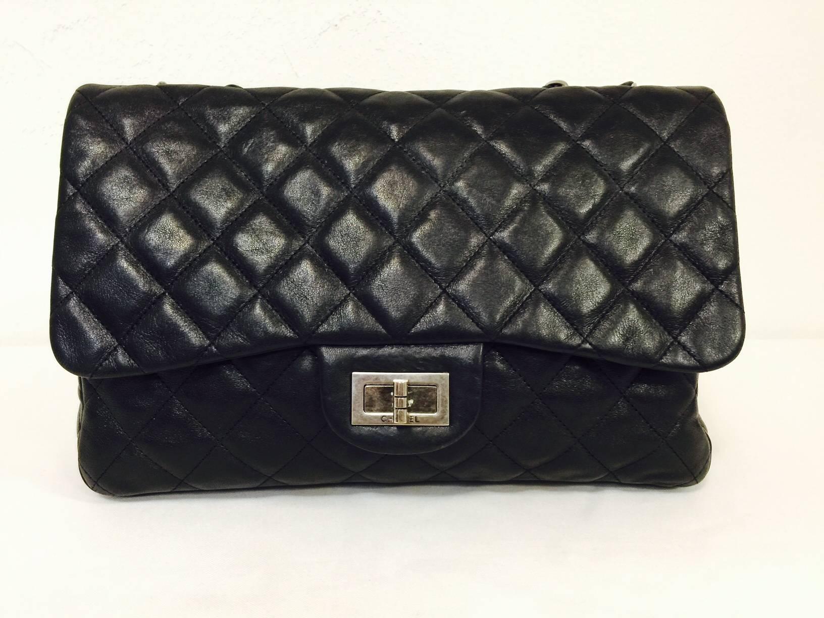 Chanel 2.55 Reissue Bag Size 226 in Black Quilted Lambskin is a highly coveted design by all devotees of Coco.  Inspired by the bag that Chanel herself introduced in February of 1955, this flap bag is next to the largest size made.  It's all