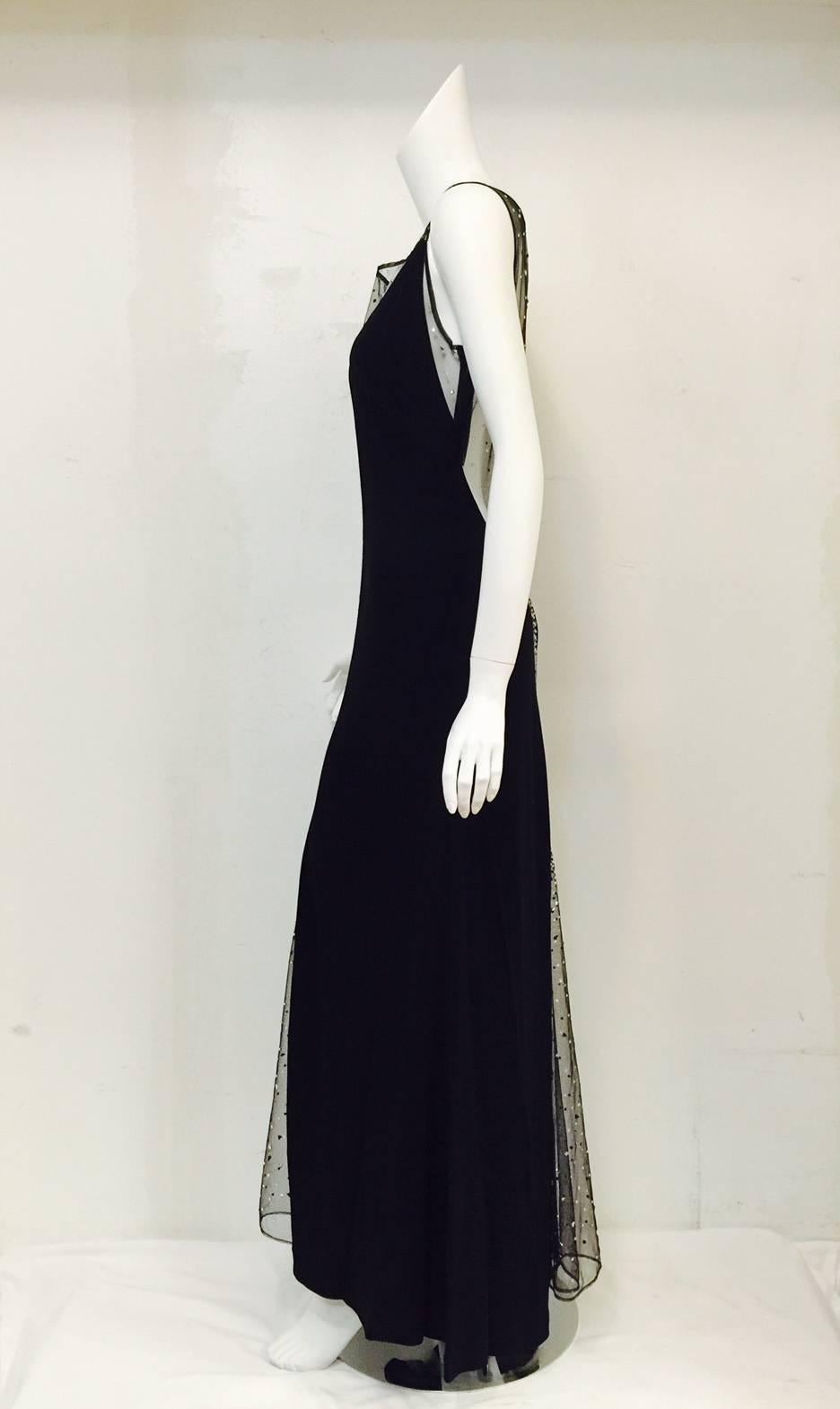 Make a statement without saying a word!  This Jiki Swarovski Crystal Embellished Black Evening Dress is sure to command the red carpet and generate 