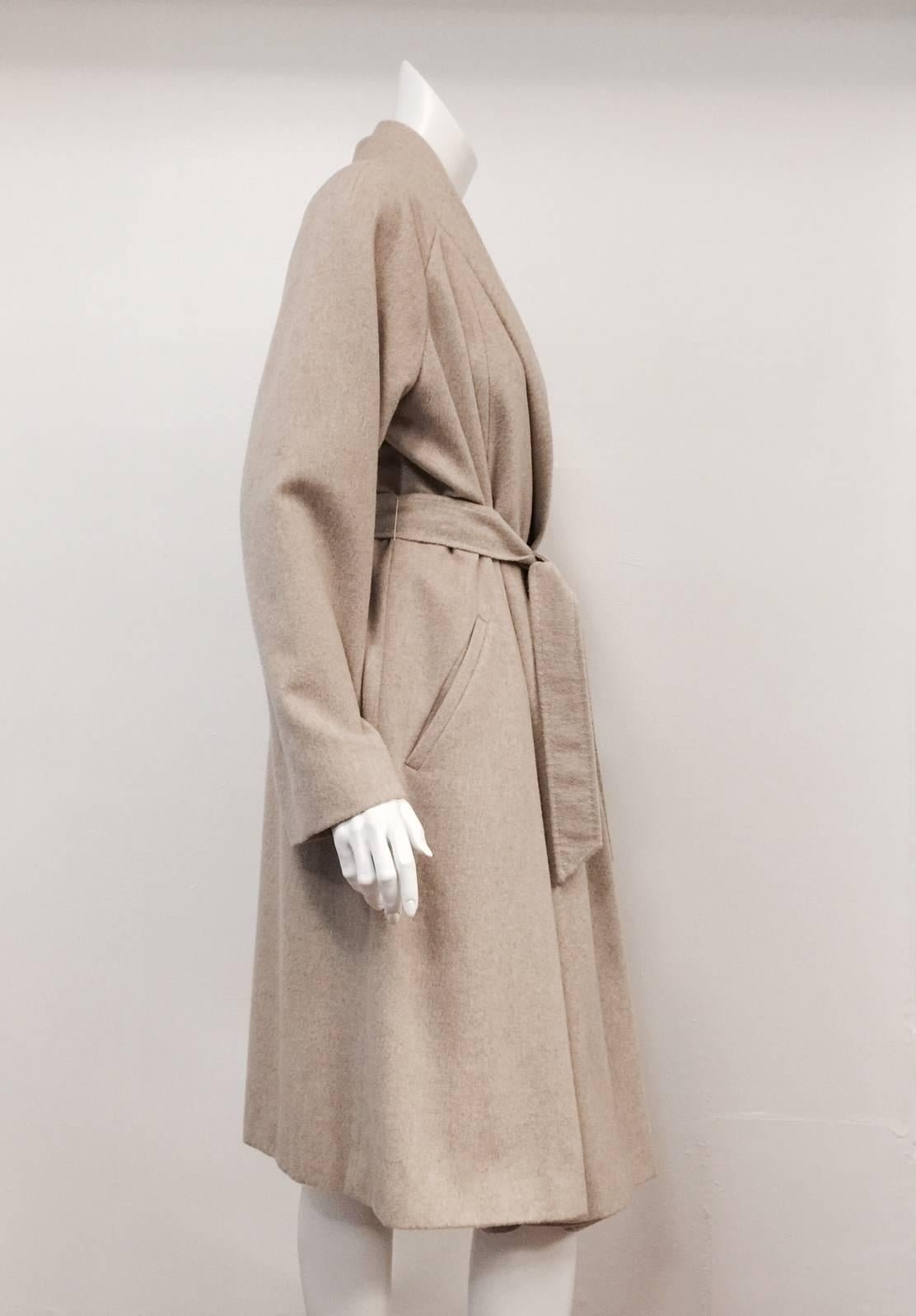 Max Mara Belted Coat  is pure luxury defined!  Features supremely soft cashmere in timeless tan.  Raglan sleeves, two slanted welt pockets, shawl collar and pick-stitched belt complete this classic look.  Fully lined in viscose with oversized