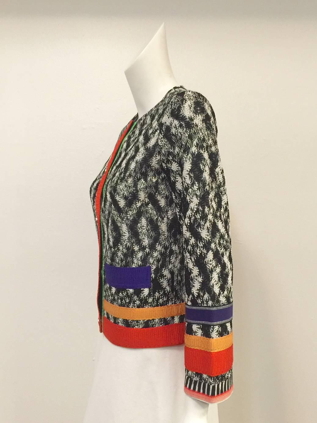 Knit Cardigan With Color Blocked Ribbon Trim is a must for connoisseurs of Missoni!    Ultra-luxurious viscose was sourced to craft this timeless design.  Features black and white abstract knit body trimmed in unforgettable bold shades of purple,