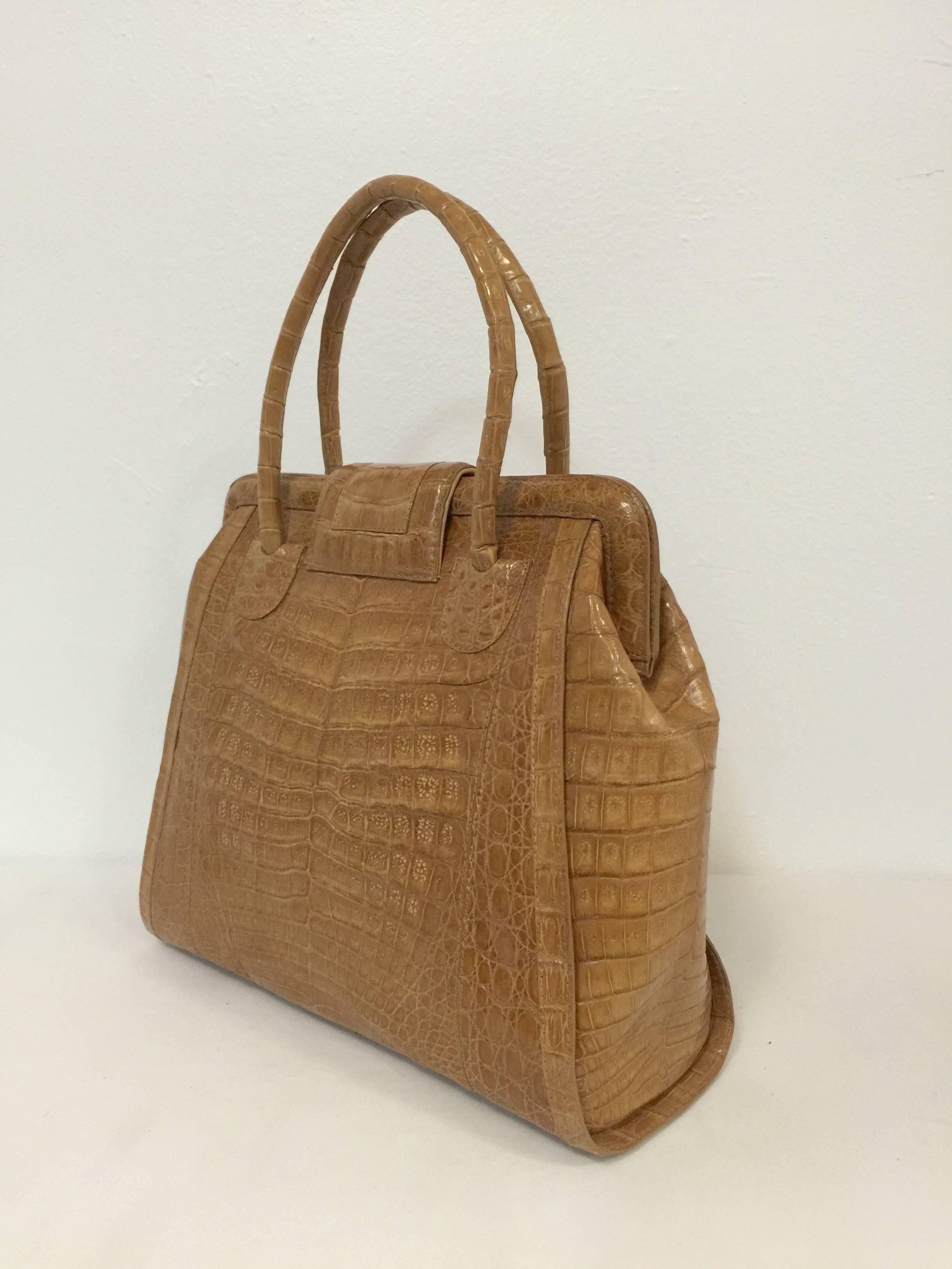 Nancy Gonzalez Crocodile Large Double Handle Bag is a must for all devotees of her designs! Crafted in Colombia, bag features ultra-luxurious crocodile in a soothing and neutral shade of caramel.  Magnetic frame closure reveals tan suede lining.