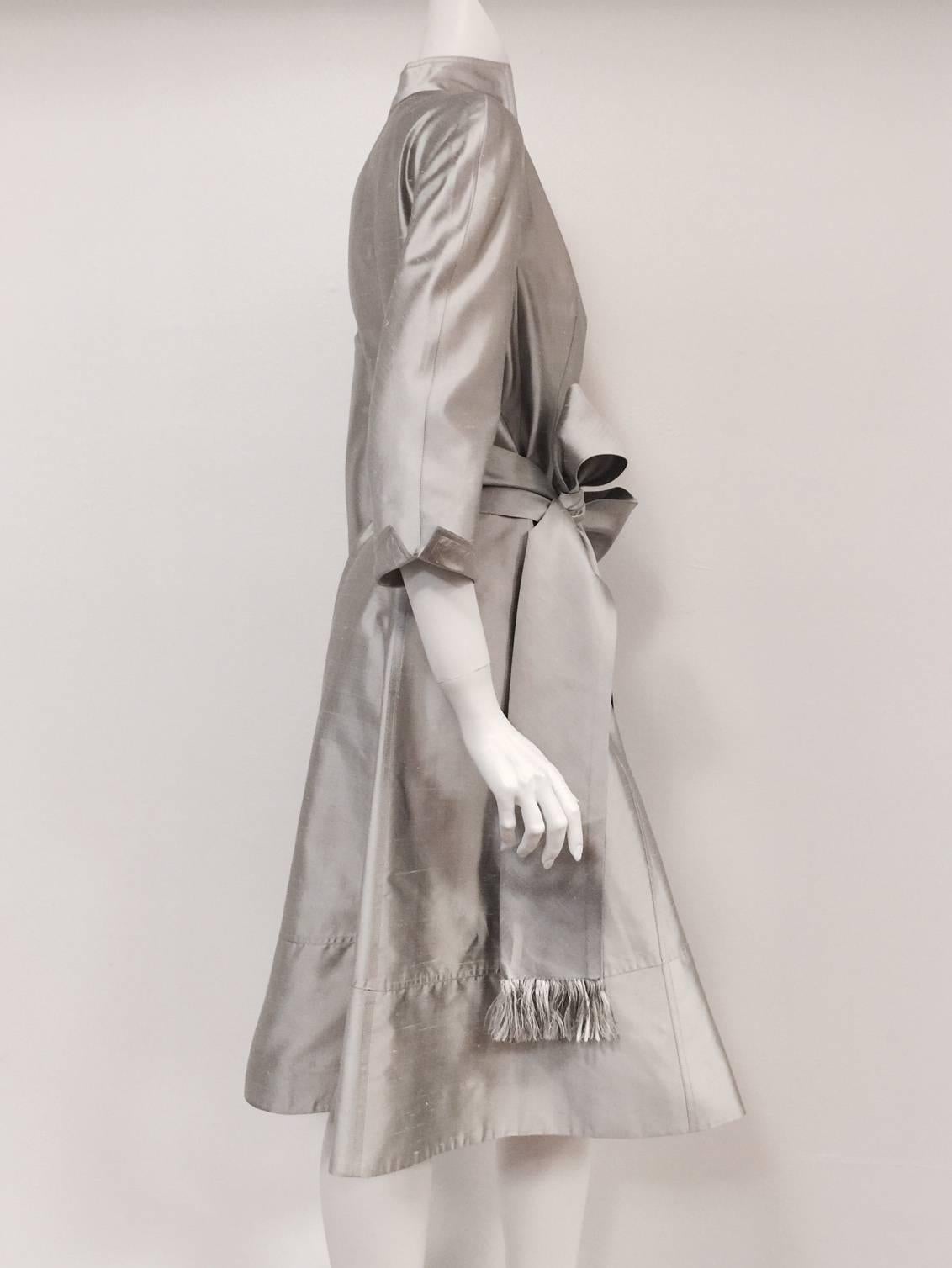 Chado Platinum Silk Shantung Wrap Dress With Sash illustrates why Ralph Rucci was invited by the Chambre de la Haute Couture to show in Paris in 2002.    He was the first American designer in 60 years to be honored with this invitation!     