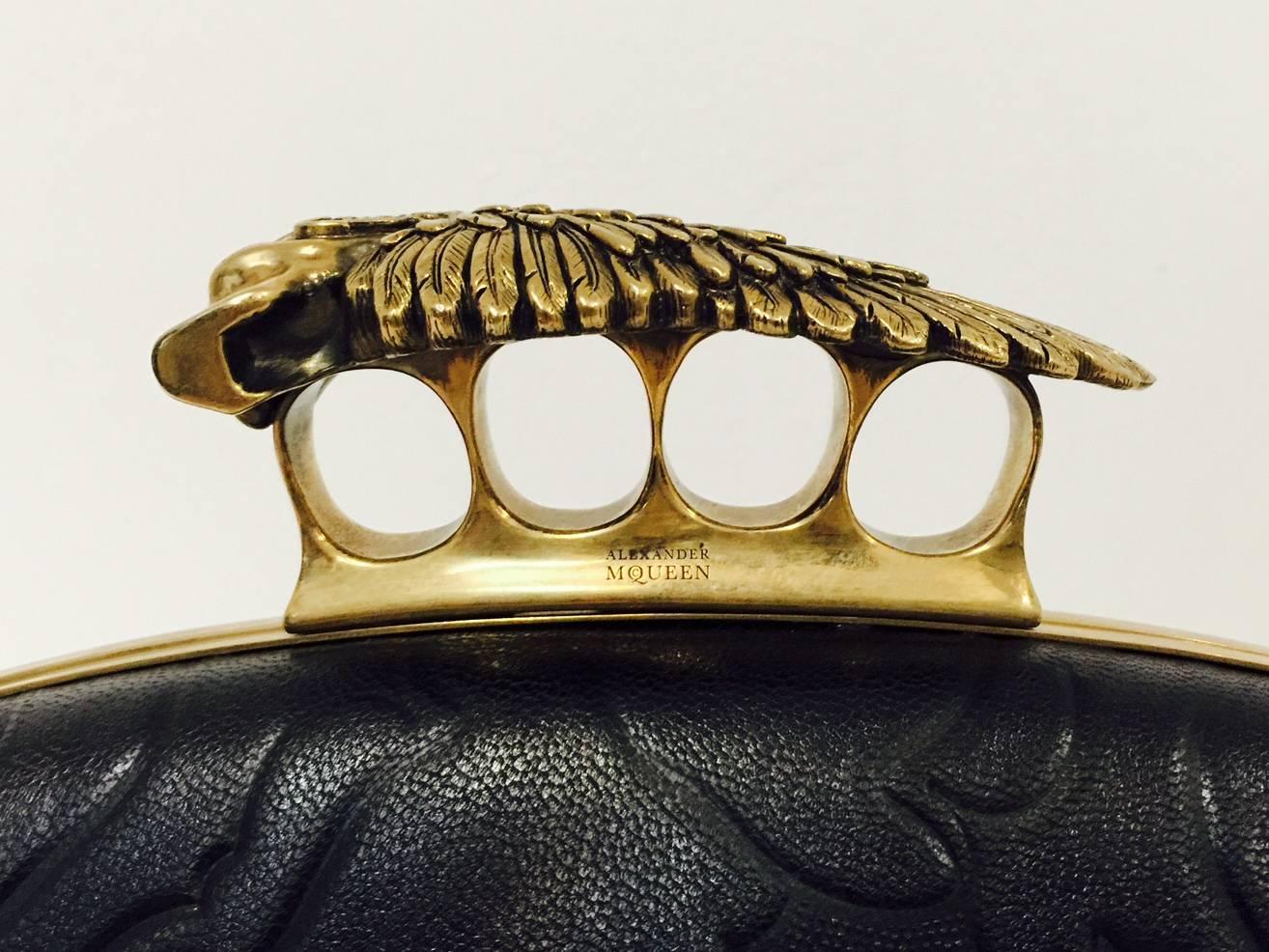 New Hell's Knuckle Duster box clutch is an instant classic and highly desired by connoisseurs and collectors of Alexander McQueen creations.  Featuring a winged death's head, brass hardware, and sumptuous leather, bag will garner admiration and a