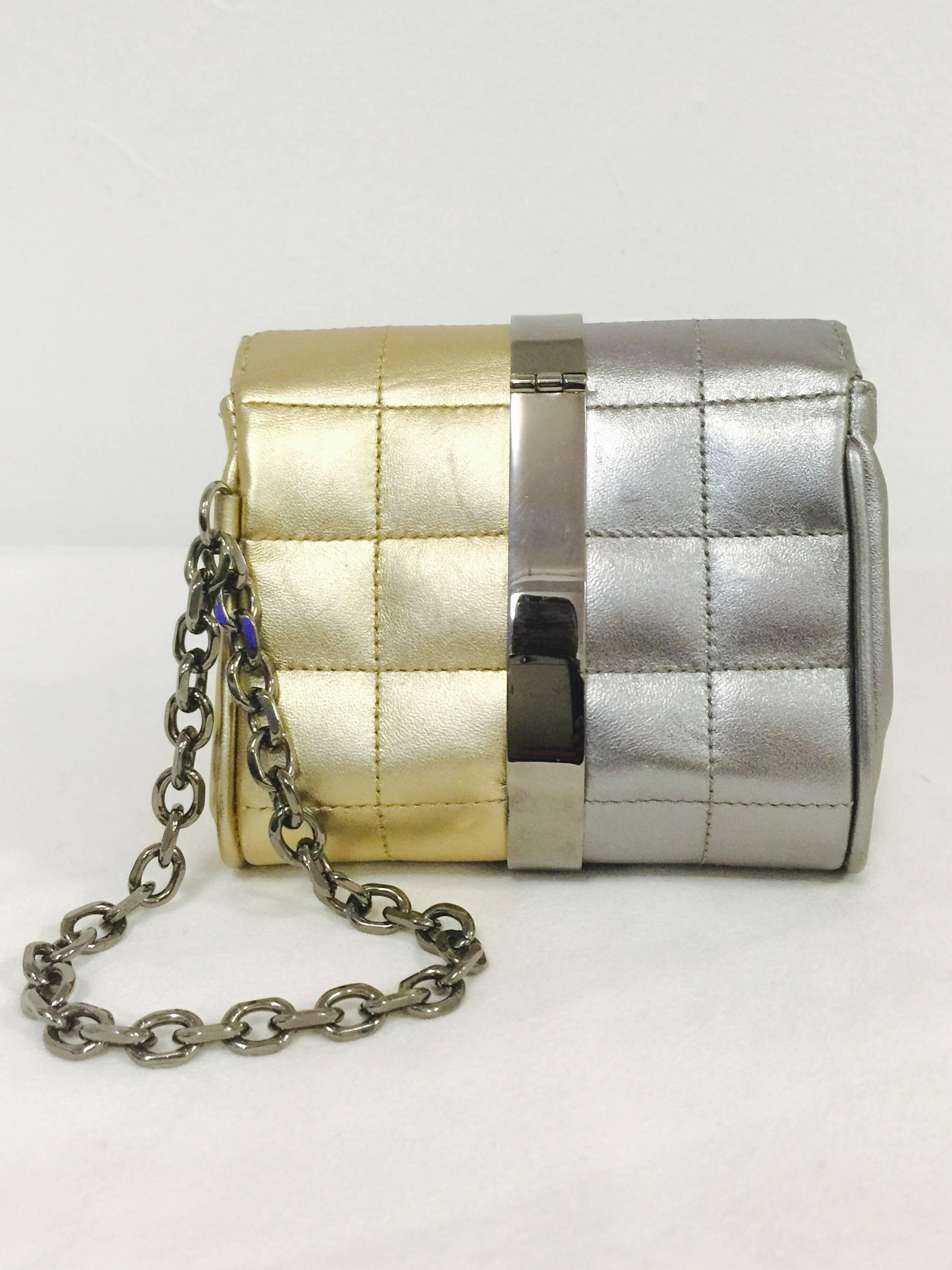 Chanel 2005 Cruise Collection Wristlet Bag is a must for any connoisseur of all things Coco!  Features signature box quilting in gold and silver metallic lambskin.  What a combination!  Warm silver tone hardware and turnlock with double 