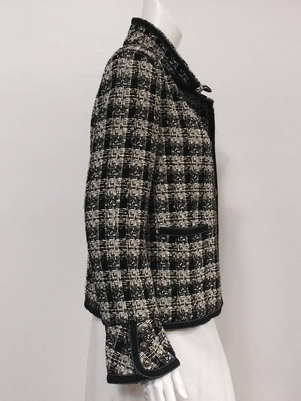 Chanel 2008 Fall Wool Tweed Jacket is worthy of Coco herself!  Features signature wool blend tweed in shades of black, mocha, and ivory with just the right amount of silver metallic thread.  Two pockets and five enamel double 