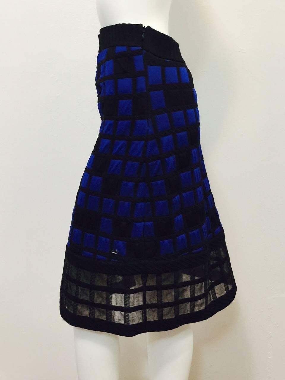 Chanel Colorblocked Quilted Skirt is as modern as Coco herself!  Features classic A-line silhouette rendered in luxurious, technologically advanced quilted black and royal blue fabric  Squares and rectangles all over are perfectly complemented by