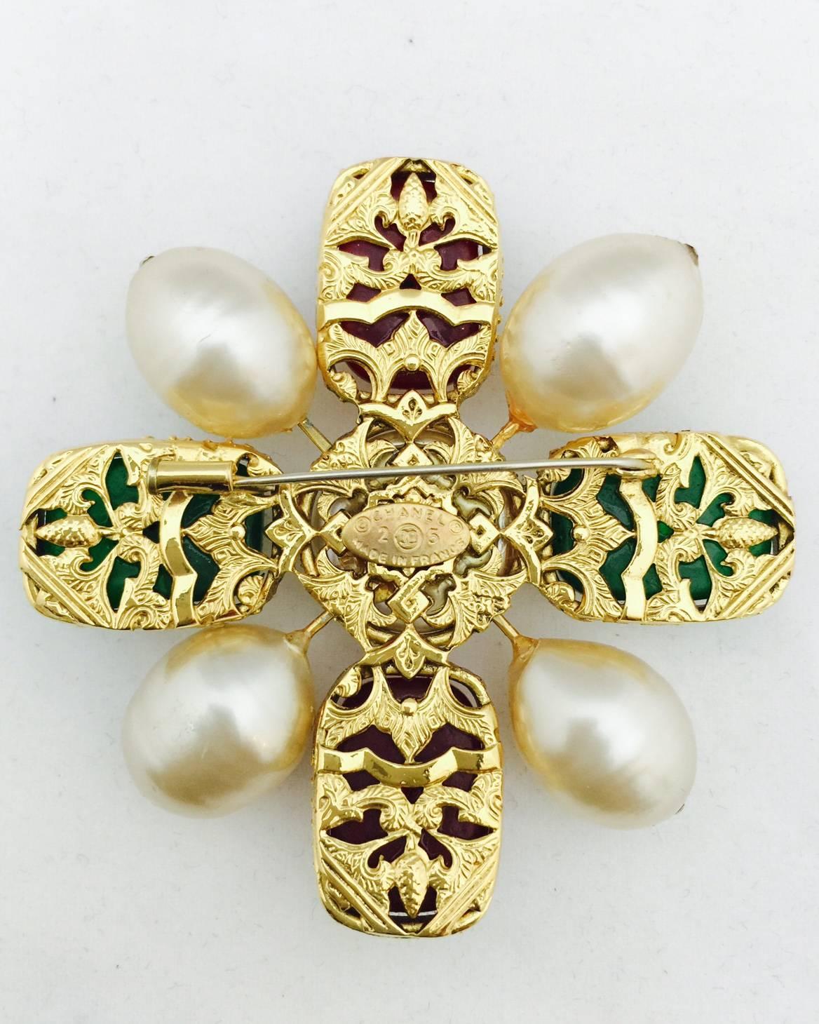 Chanel Red and Green Gripoix Glass Maltese Cross Brooch is worthy of Coco herself!  Crafted using advanced glass making techniques perfected by Augustine Gripoix in the 1860s, this large Maltese Cross is worthy of any connoisseur of costume jewelry
