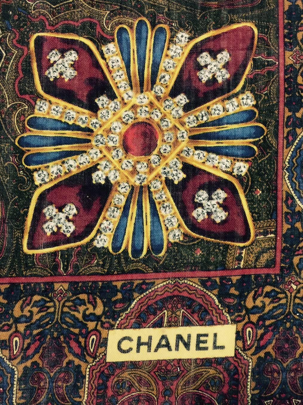 Chanel Wool Blend Printed Shawl  is classic Coco!  Featuring Mademoiselle's signature oversized, bejeweled Gripoix brooches, this substantial shawl is sure to become a 
