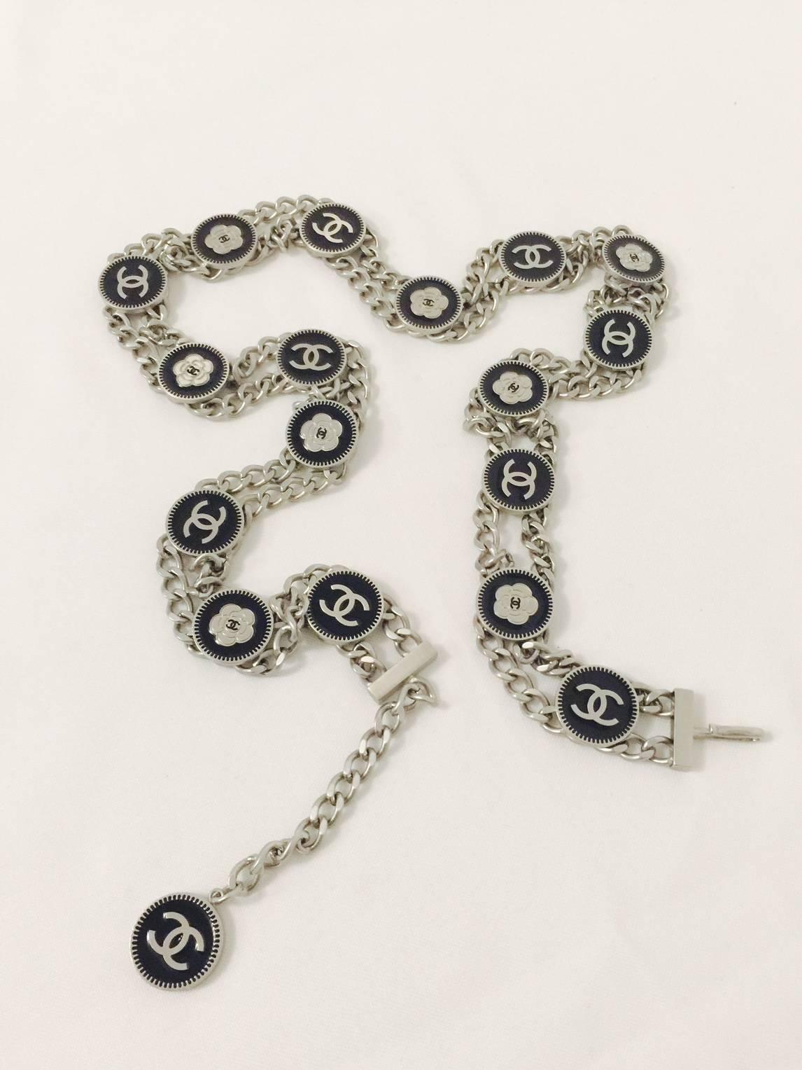 Chanel Spring 2006 Silver Tone Chain Belt is a wonderful alternative to the gold tone leather interwoven variety!  Features double chains connected by 17 black enamel medallions with embossed double 