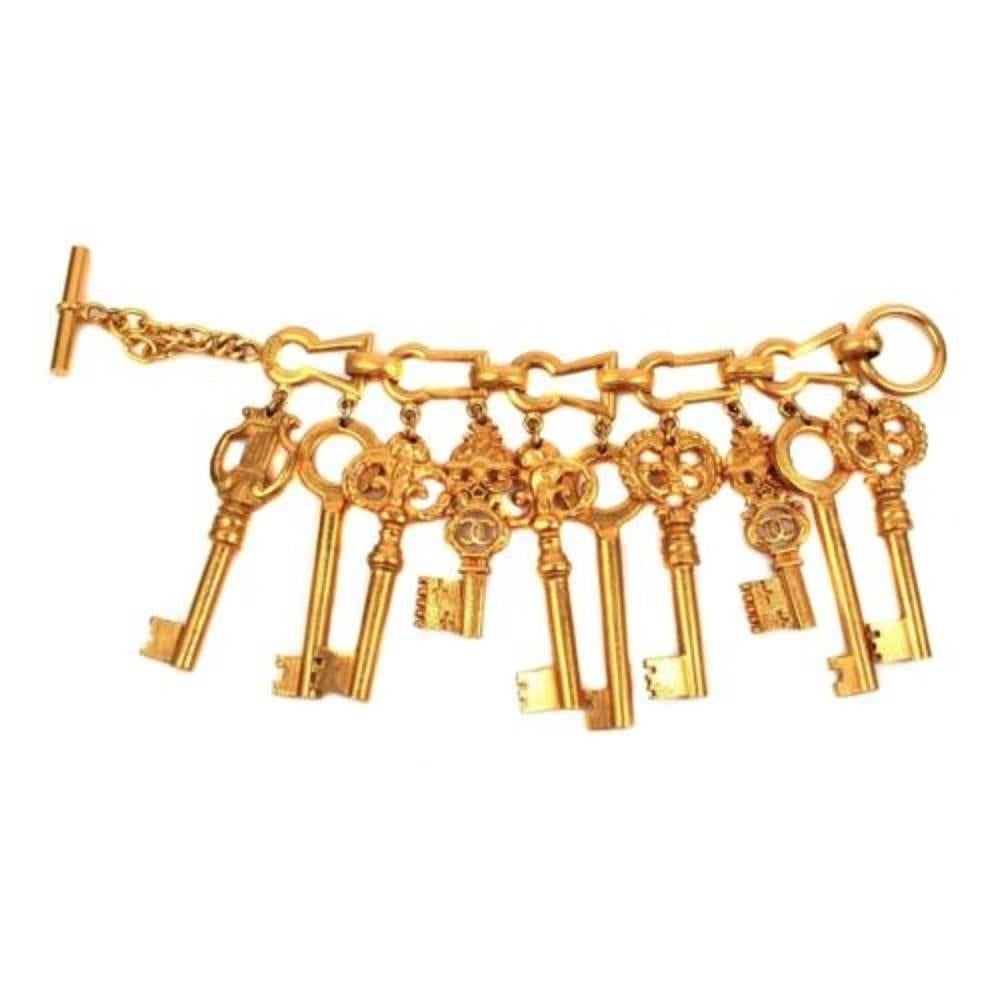 Collectible Chanel 1993 Spring Charm Bracelet opens many doors!  Features 10 gold tone skeleton key charms, antique engraving motif and toggle clasp closure.  Signature double 