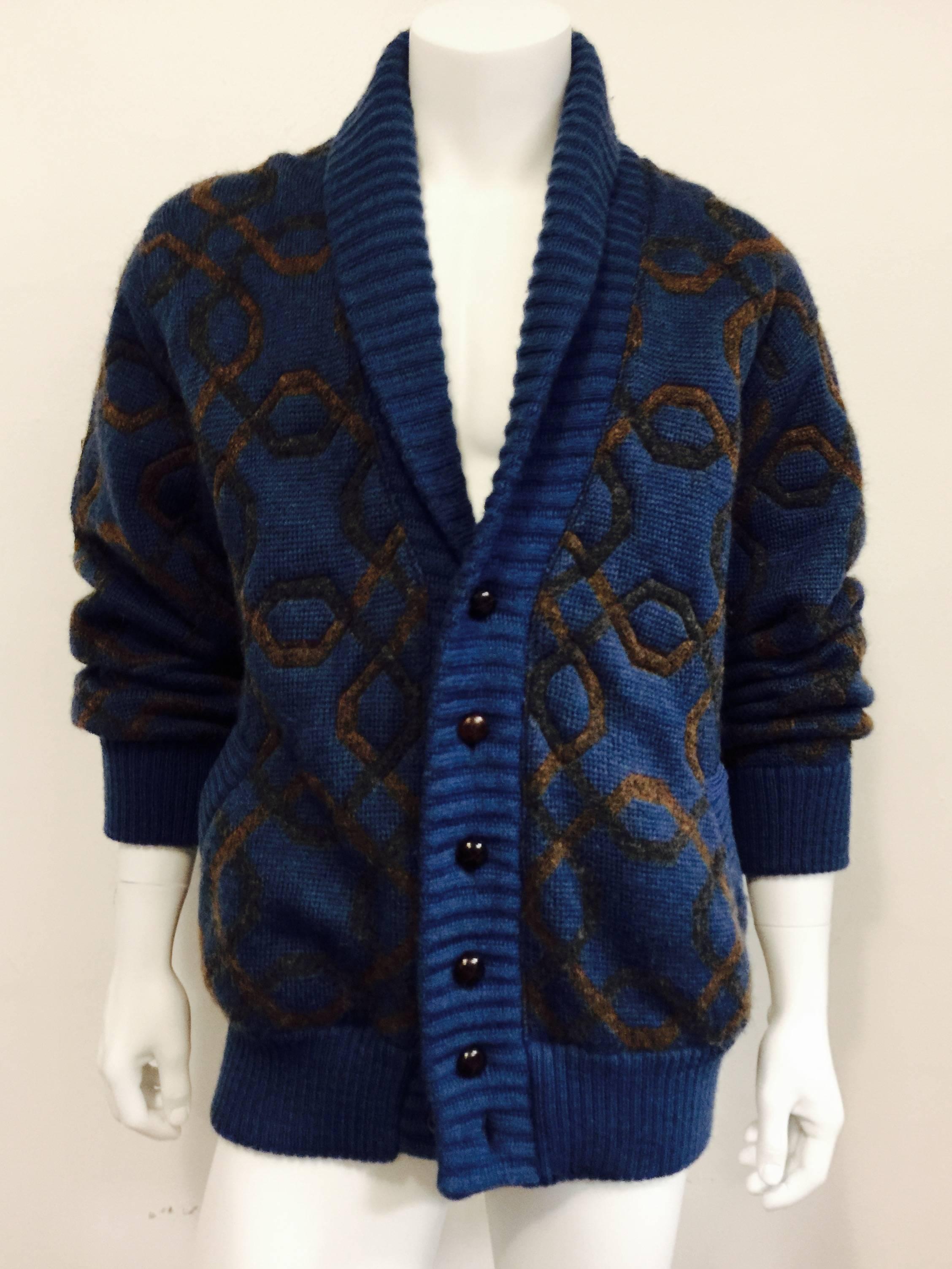 Fab vintage 1970's cuddly "cardie" from the House of Gucci featuring a chain pattern, with solid shawl collar, welted cuffs and hem and six leather covered buttons.  There are two welted slit pockets on the front.  Heavy enough for