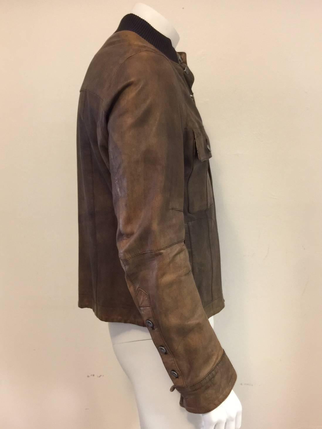 Cool D & G jacket in soft  shades of burnished tobacco leather.  Welted hem and cuffs, two side pockets, with a perforated fabric lining  for extra cool!  The buttons are iconicaly marked with D & G around the rim.
