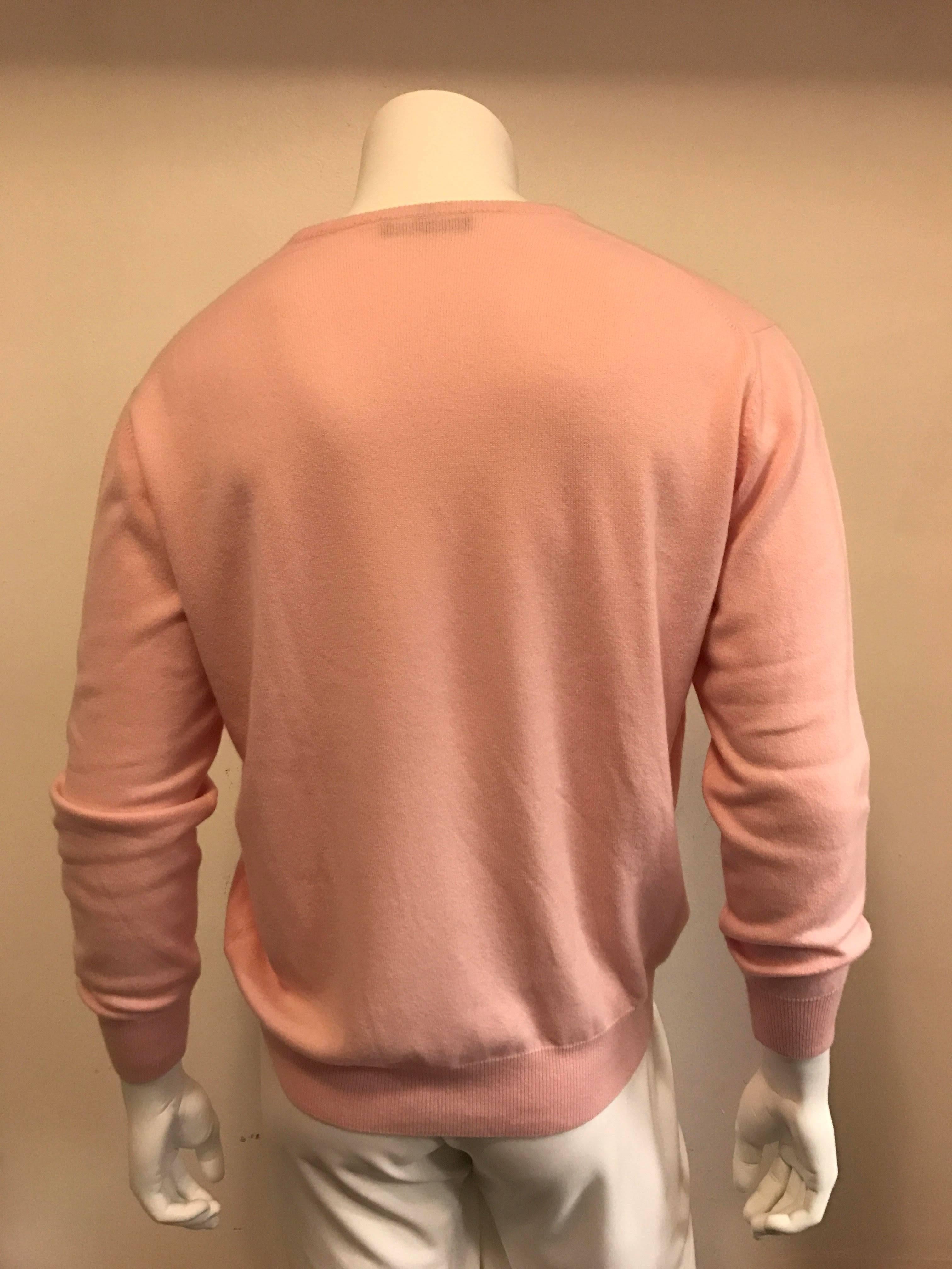 This soft pink Loro Piano is sumptuously luxurious in baby cashmere. The V neck measures approximately a 7