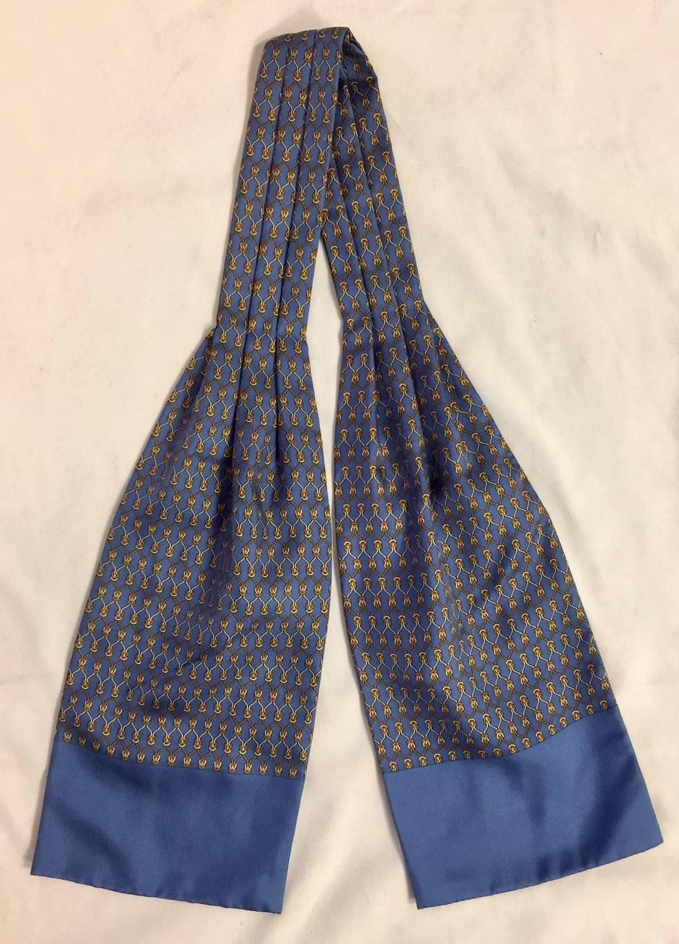 This elegant Hermes cravat is in a double thickness silk, with solid colour endings, and a chain link pattern in shades of classic blues. Cut a dashing figure in this timeless cravat!