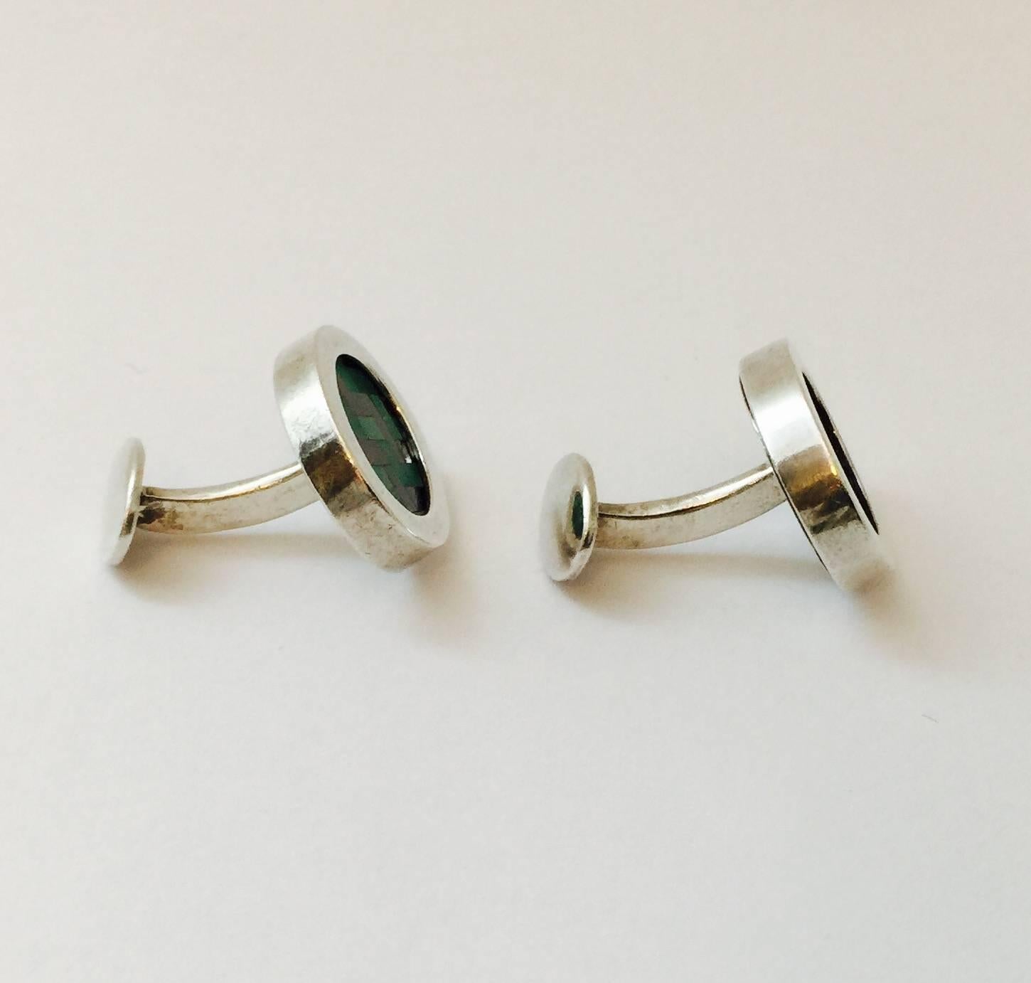 These elegant vintage Tiffany cufflinks are in a substantial sterling silver oval shape, with chevron tiles of enamel in the centre in shades of green.  Stamped Tiffany and Sterling Silver.  Finish off French Cuffs in style. Suitable for a woman's