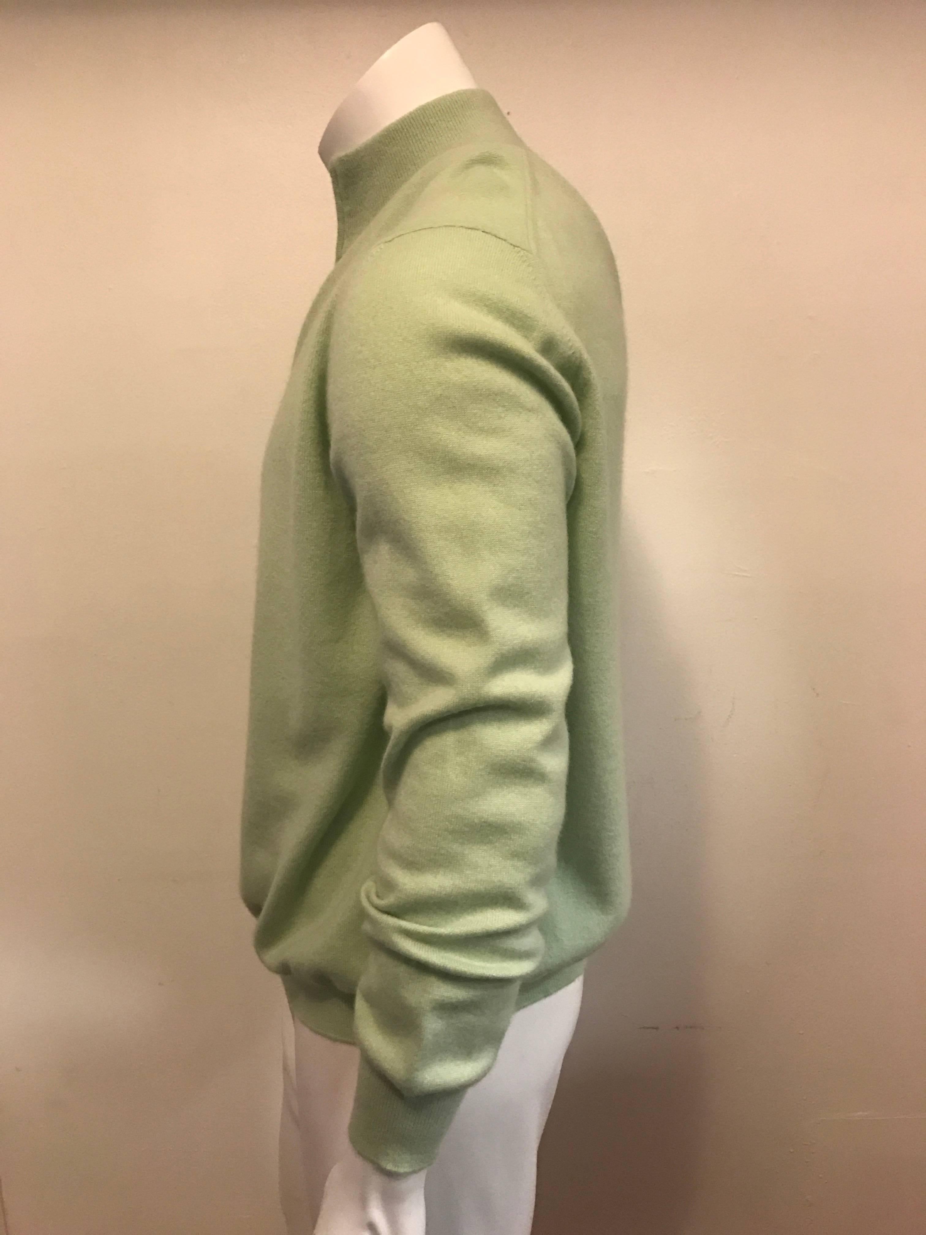 Elegant sweater cardigan by Malo, in a soft shade of mint in the finest Italian cashmere.  A mock turtle neck with full length zipper, the chest measures 50