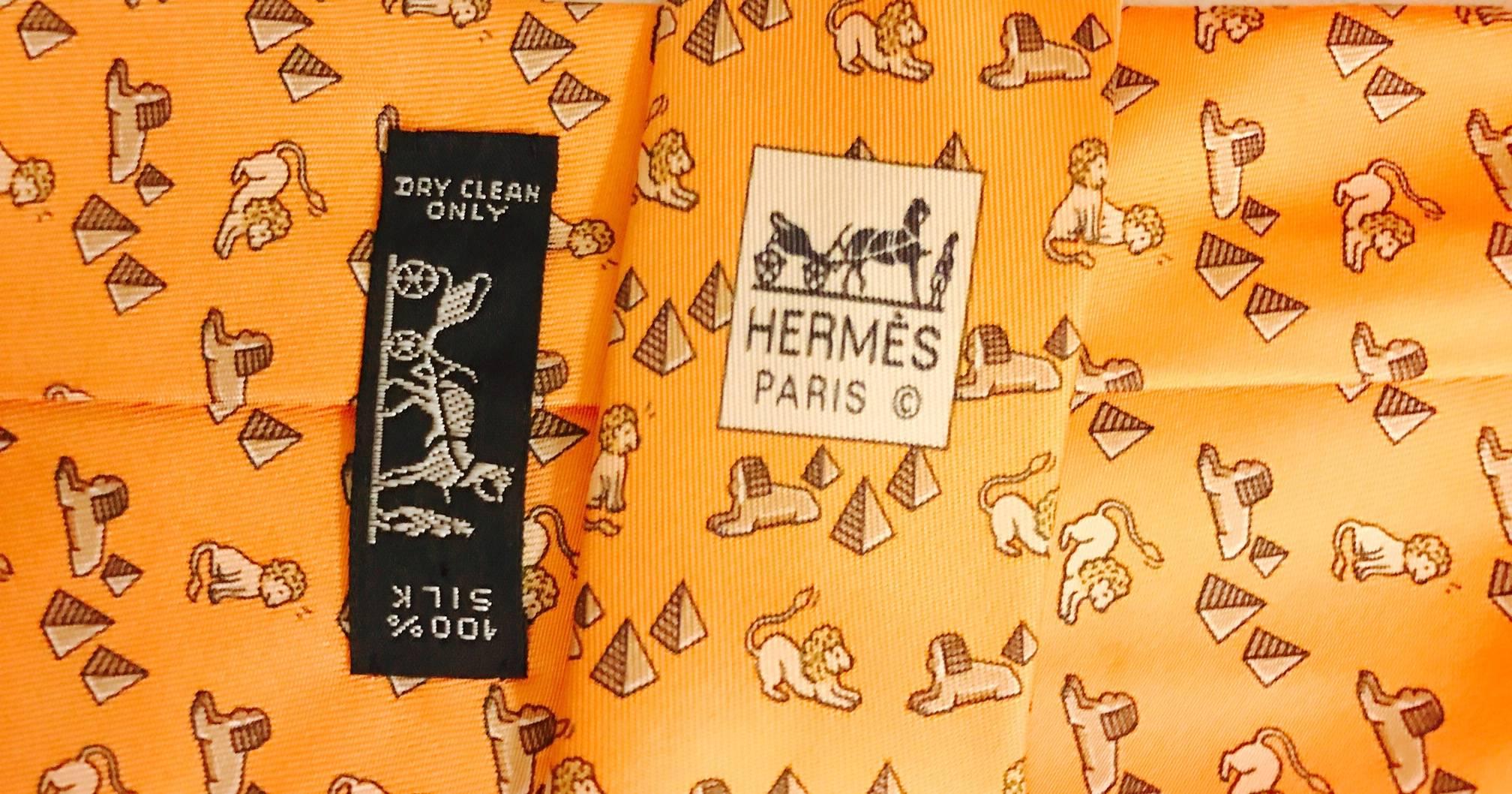 A men's whimsical 1980's tie from Hermes, with a play on an Egyptian theme, the rare ancient lion, which represented power and vitality, seems to want to play with the sphinx guarding the pyramids!  In tones of apricot and gold, a wonderful addition