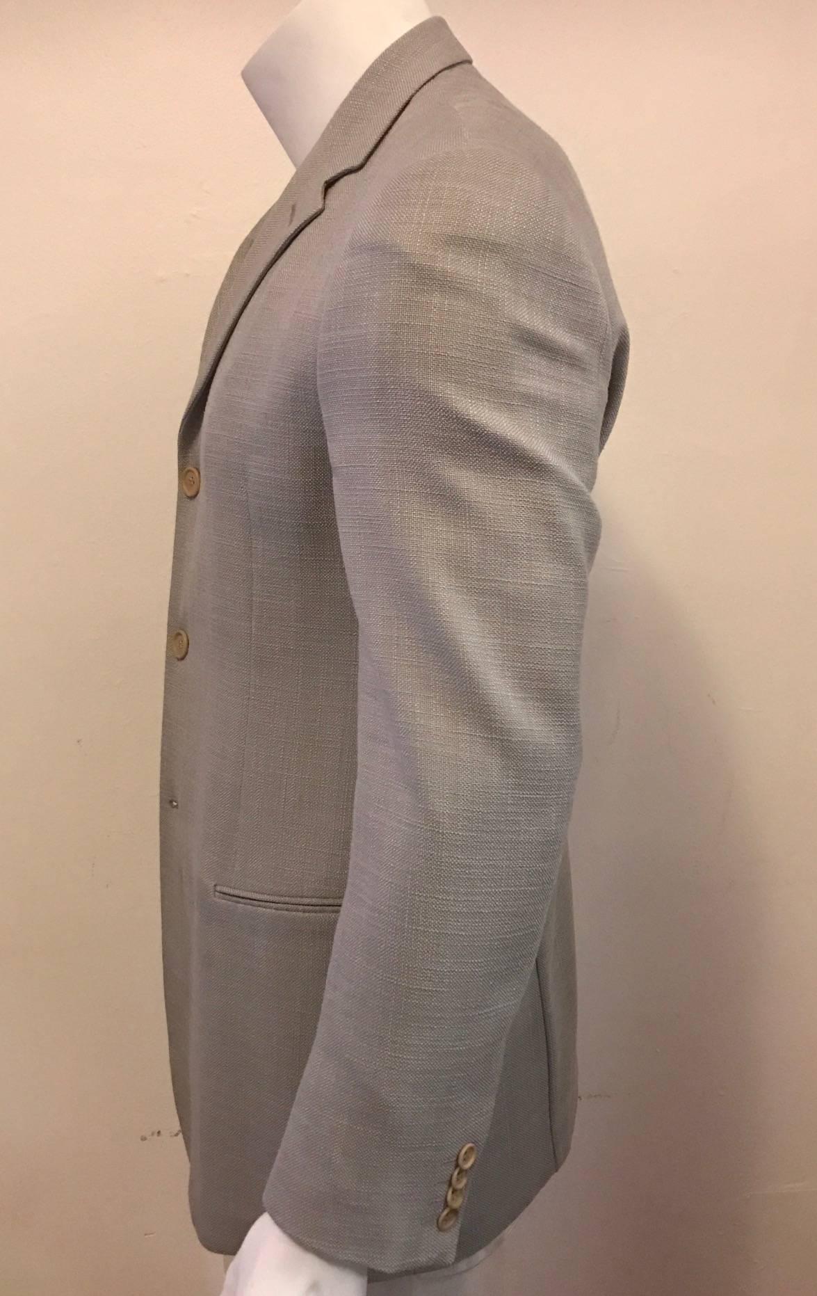 Men's Giorgio Armani Black Label unconstructed long line sport coat in 80% silk and 20% cotton.  Small shoulder pads, bemberg, and lined sleeves.  Three button closure, two slit front pockets that have not been untacked.  A wonderful lightweight