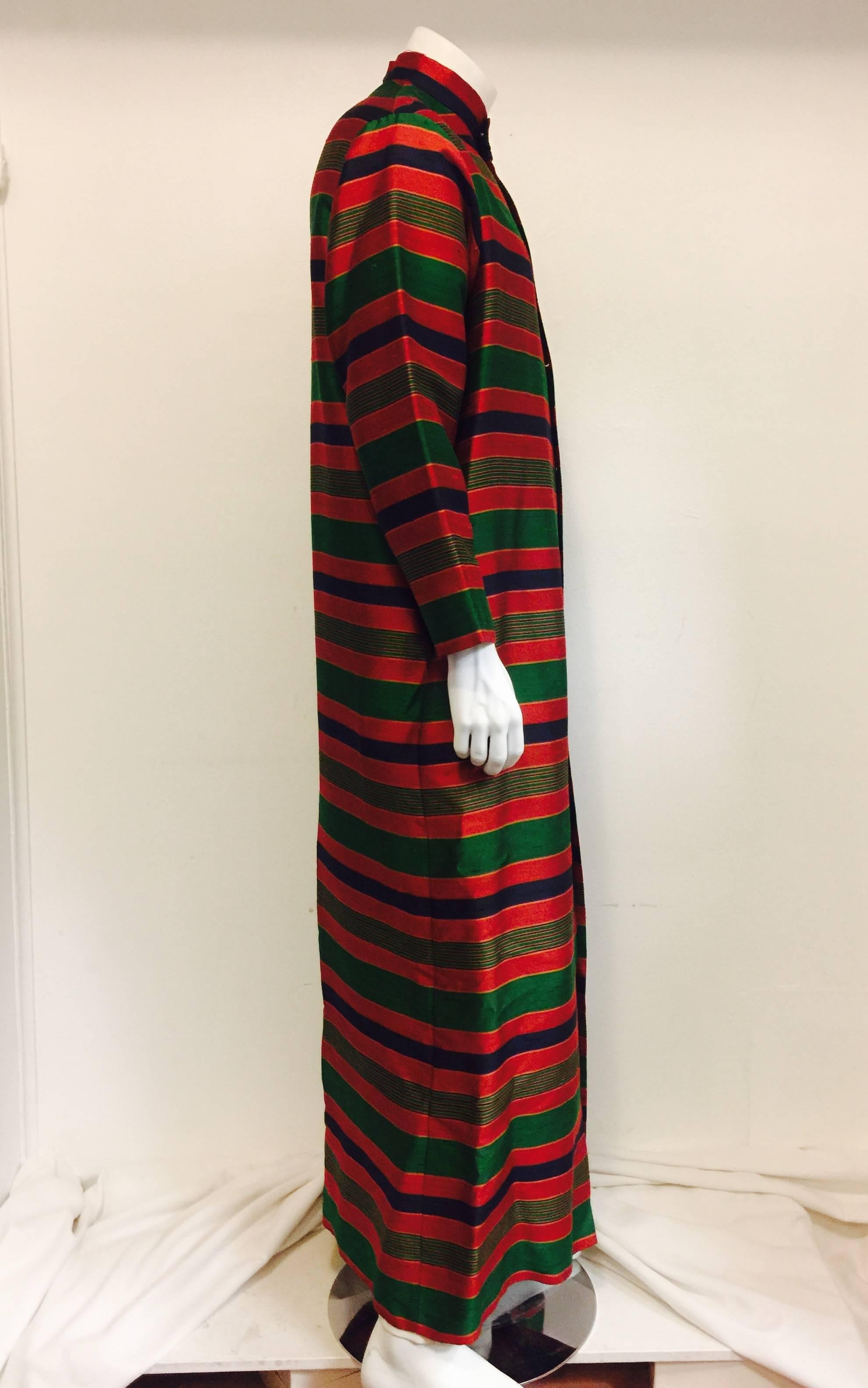Alexander Shields was a fashion house from the 1950's to 1970's on Park Avenue, N.Y.  This fabulous vintage robe is in  multi coloured jewel tones stripe slub textured acetate, with the look of slub silk.  Seven mother of pearl snap buttons in