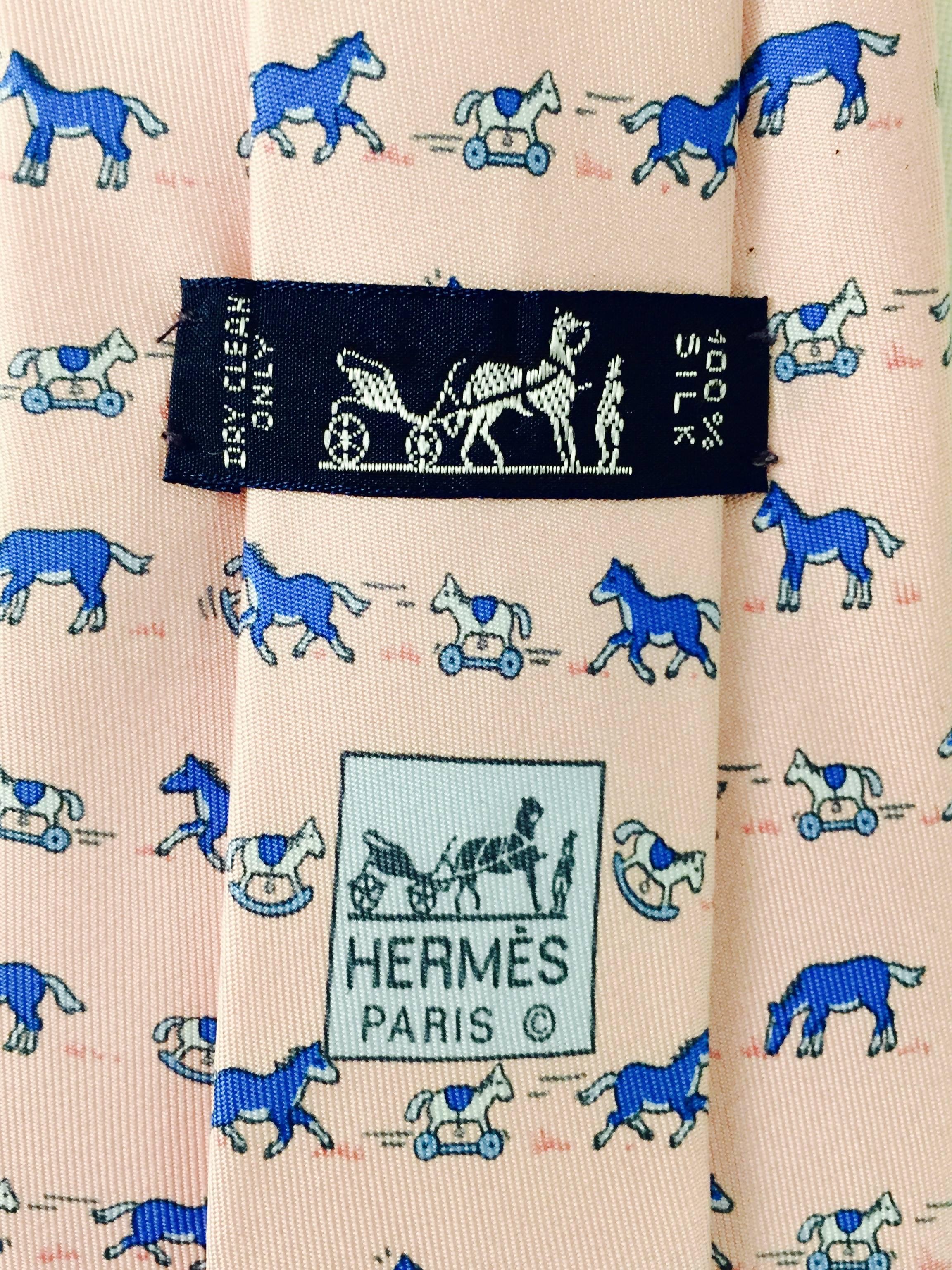 Is there a baby in your man's future? What better way to announce it but with this adorable Hermes vintage tie with a pony and rocking horse in blue and white playing across the pale pink silk. OH BABY!