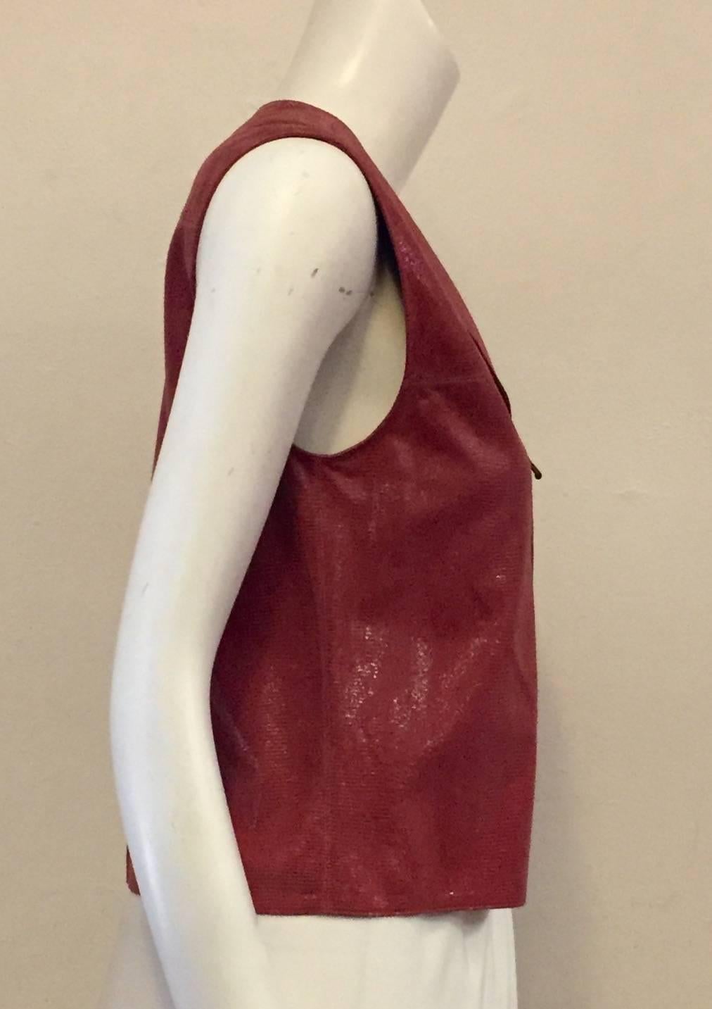 Classic Chanel meets current style, in this up to date vest in  striking Salmon colored goat skin.  Notch collar sleeveless vest can be worn by itself or with a blouse underneath accentuating its uniqueness.  Authentic Chanel, with charm and pizzazz