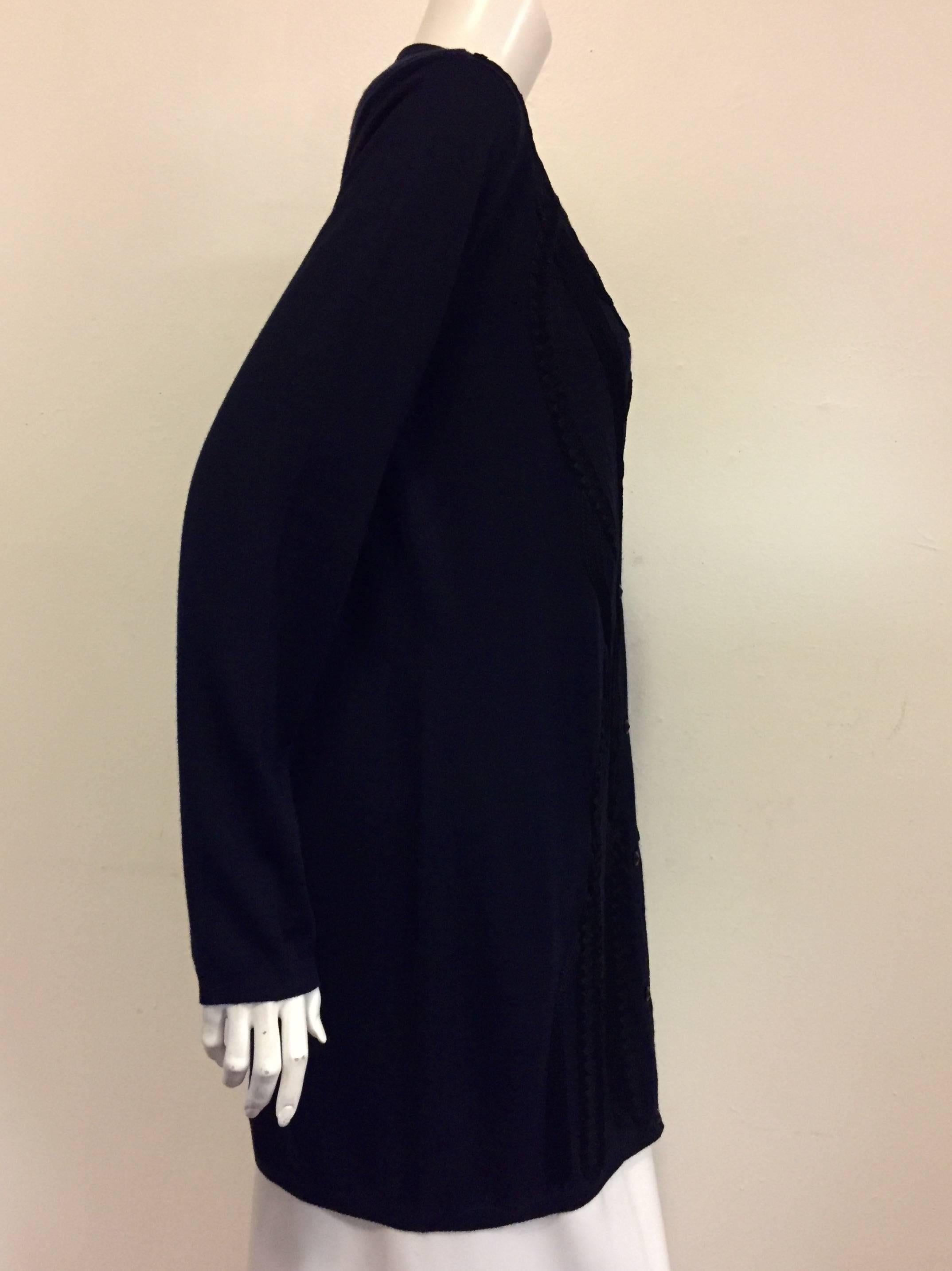 Elegant Escada Navy twinset is a classic design that promises many years of luxurious wear!  Features a sophisticated 70% Wool/30% Silk knit, longer length, and eight button front closure.  Ribbed hem, cuffs and neckline finish the look.  The 
