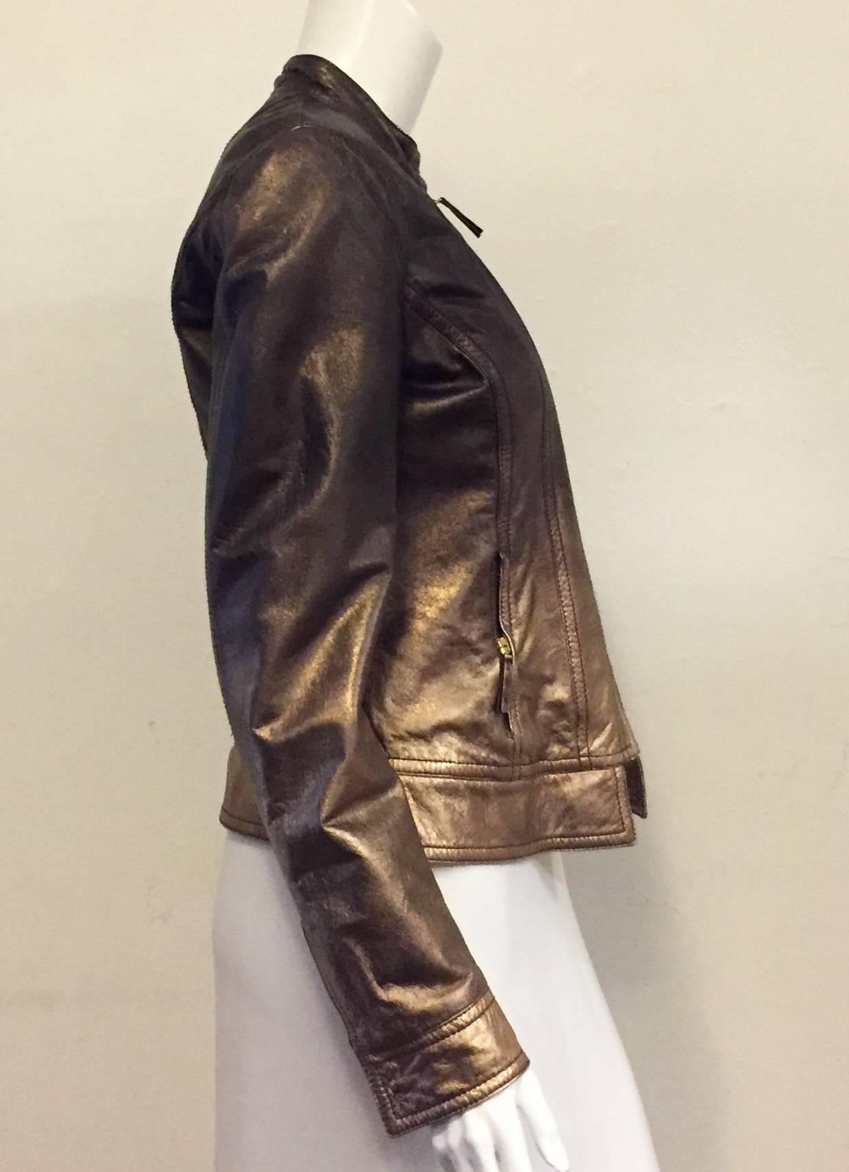 Recognizable Roberto Cavalli's signature design in this Leather jacket with Nehru collar and hidden snap closure.  As always, the difference is in the details, the delicately soft real leather in ombre shades of bronze to copper, with 2 front