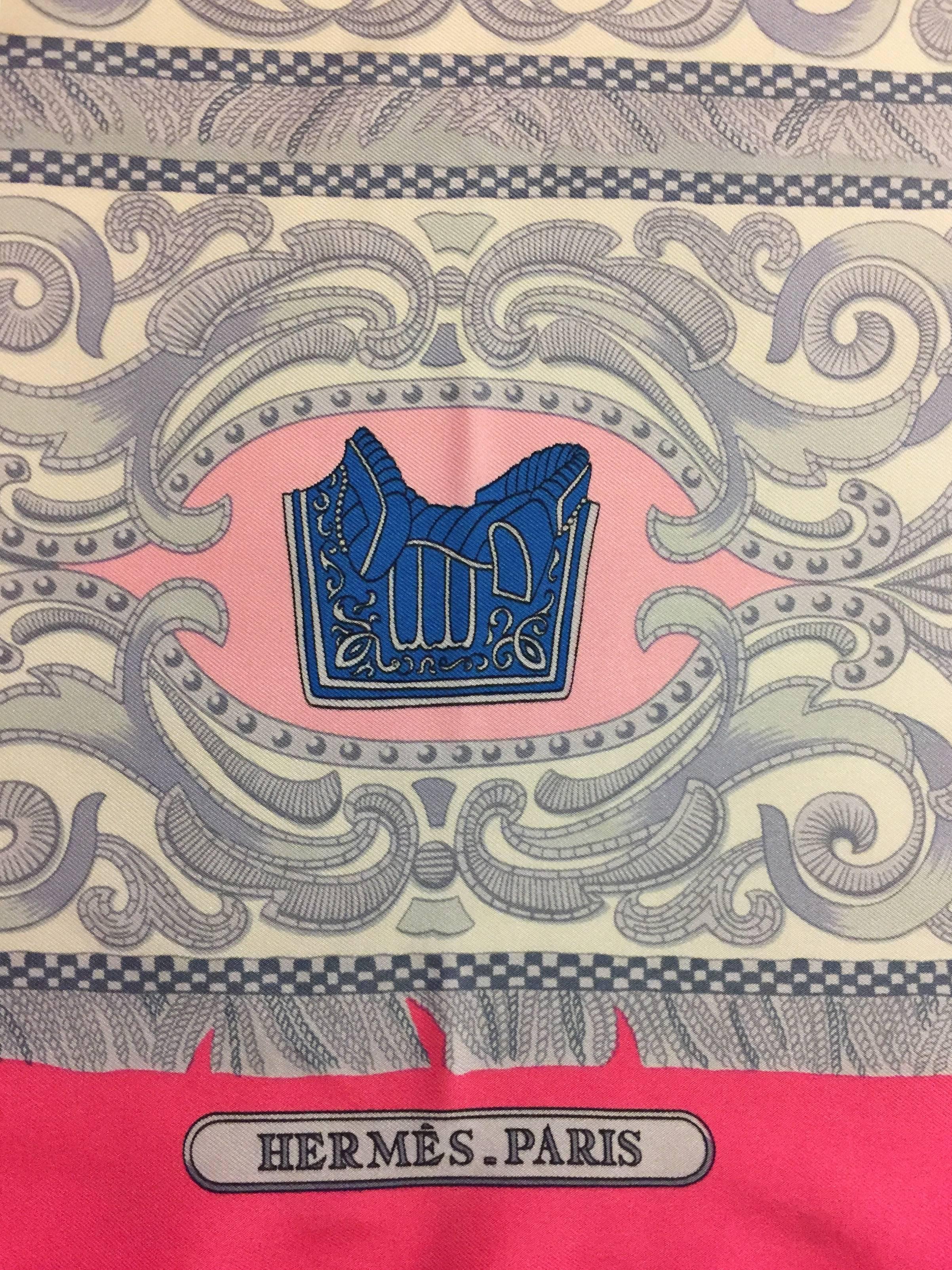 Beautiful Hermes Vintage 1970's Silk Twill scarf in the La Presentation pattern.  This scarf features a Hot Pink border and white background with printed equestrian vignettes in grey, blue and brown. At the top, on the Hot Pink border, the name of