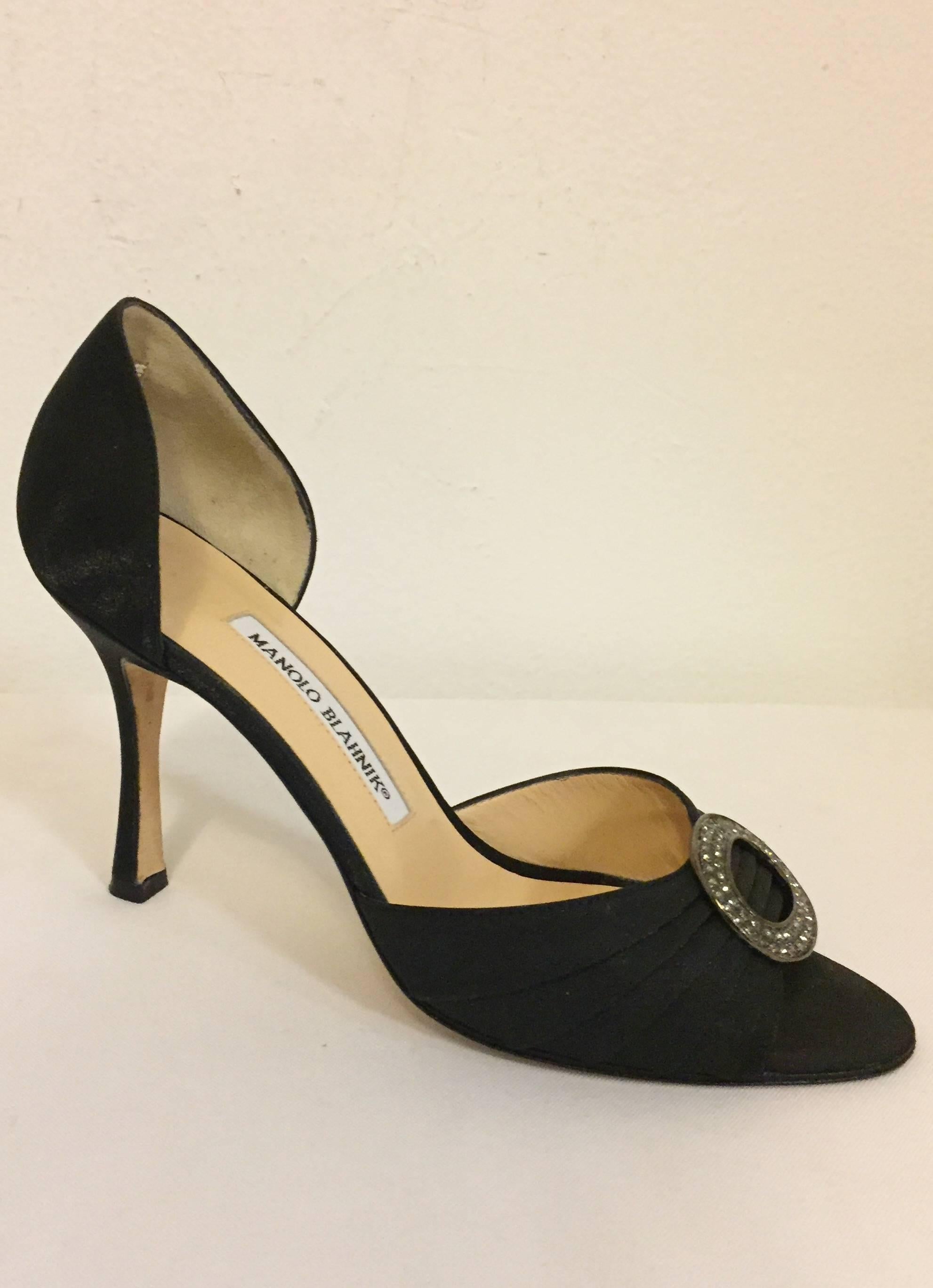 Twilight comes and out for the night in these magnificent Manolo's in Black Silk,  gathered frontal band with an oval crystal brooch.  This pair of D'Orsay style shoes is in excellent condition in a size EU 38 and US 8.  Beautiful and beneficial,