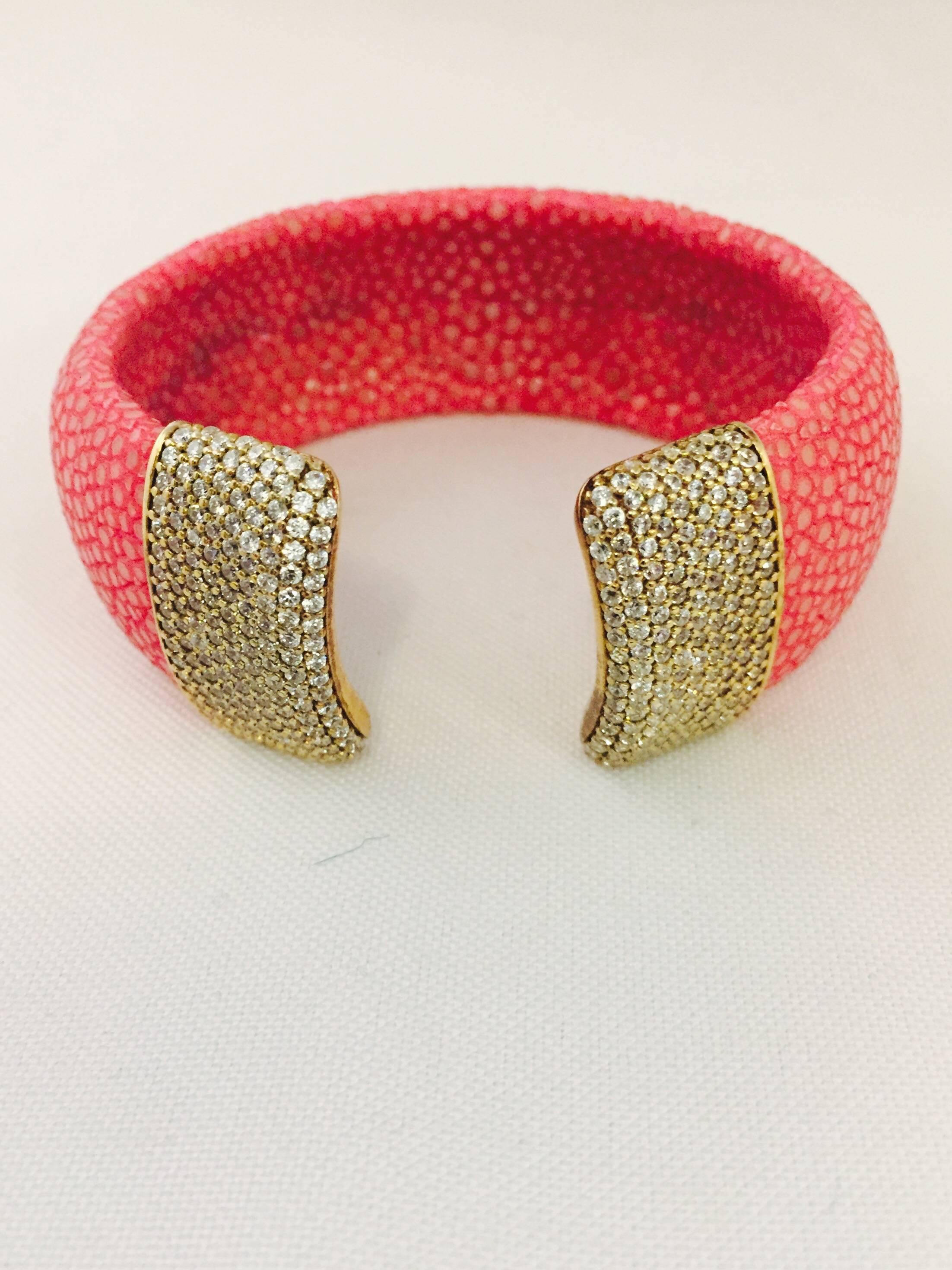 D. Dream has fabricated this shagreen cuff in hot pink!  So very today!  Each open end is capped in gold tone encrusted with Swarovsky crystals.  Casual or formal this eye catching cuff would be a fantastic addition to your jewelry wardrobe. 