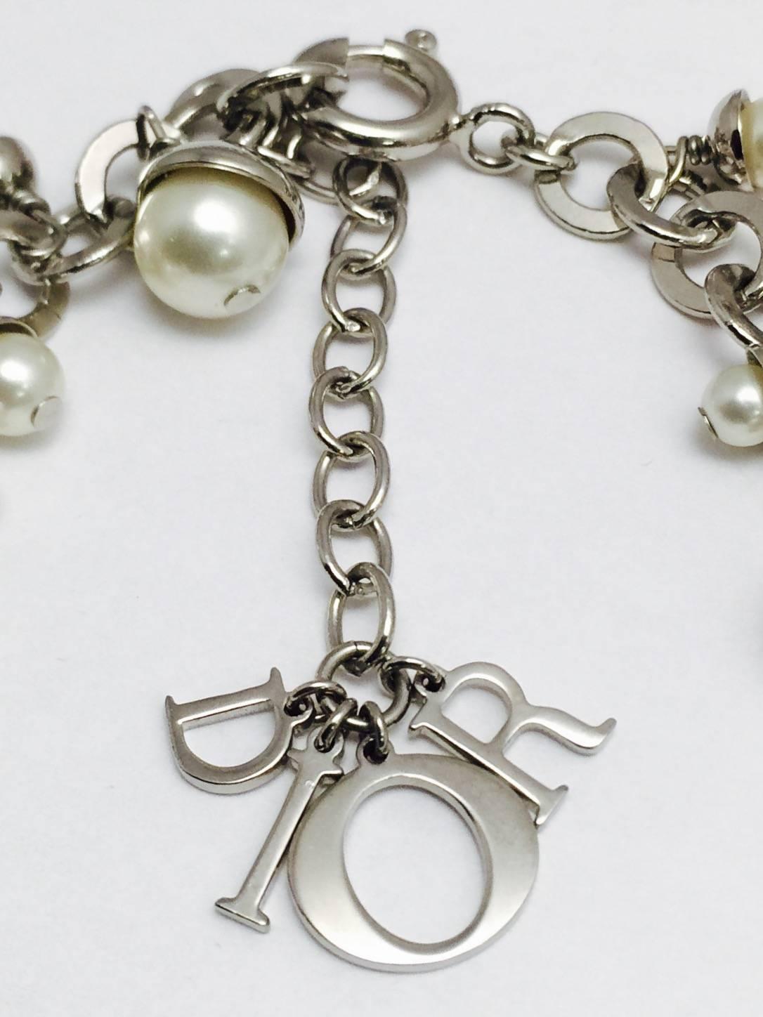 Dior is known for high style!  This incredible necklace features end capped faux pearls ranging from 4mm to 8mm.  Each pearl dangles effortlessly from a silver tone open link necklace. End caps add sparkle and drama.  The movement as you walk (or