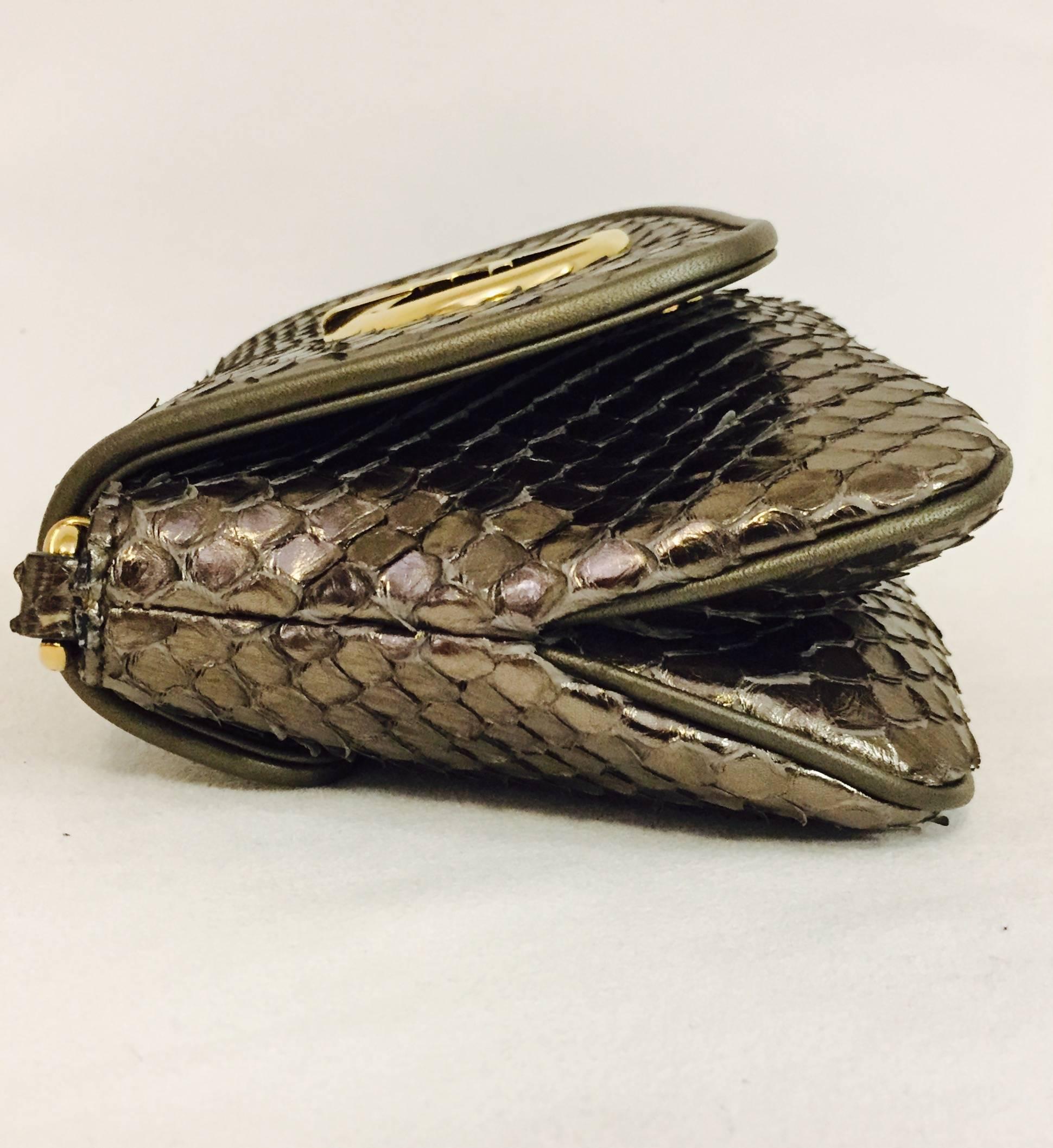 Glimmering Gucci bronze Python cross body bag, is from the 1973"Collection inspired by the a bag found in the archives dated "1973", a classic design with a modern twist released in 2010.
Achieve unparalleled glam with this authentic