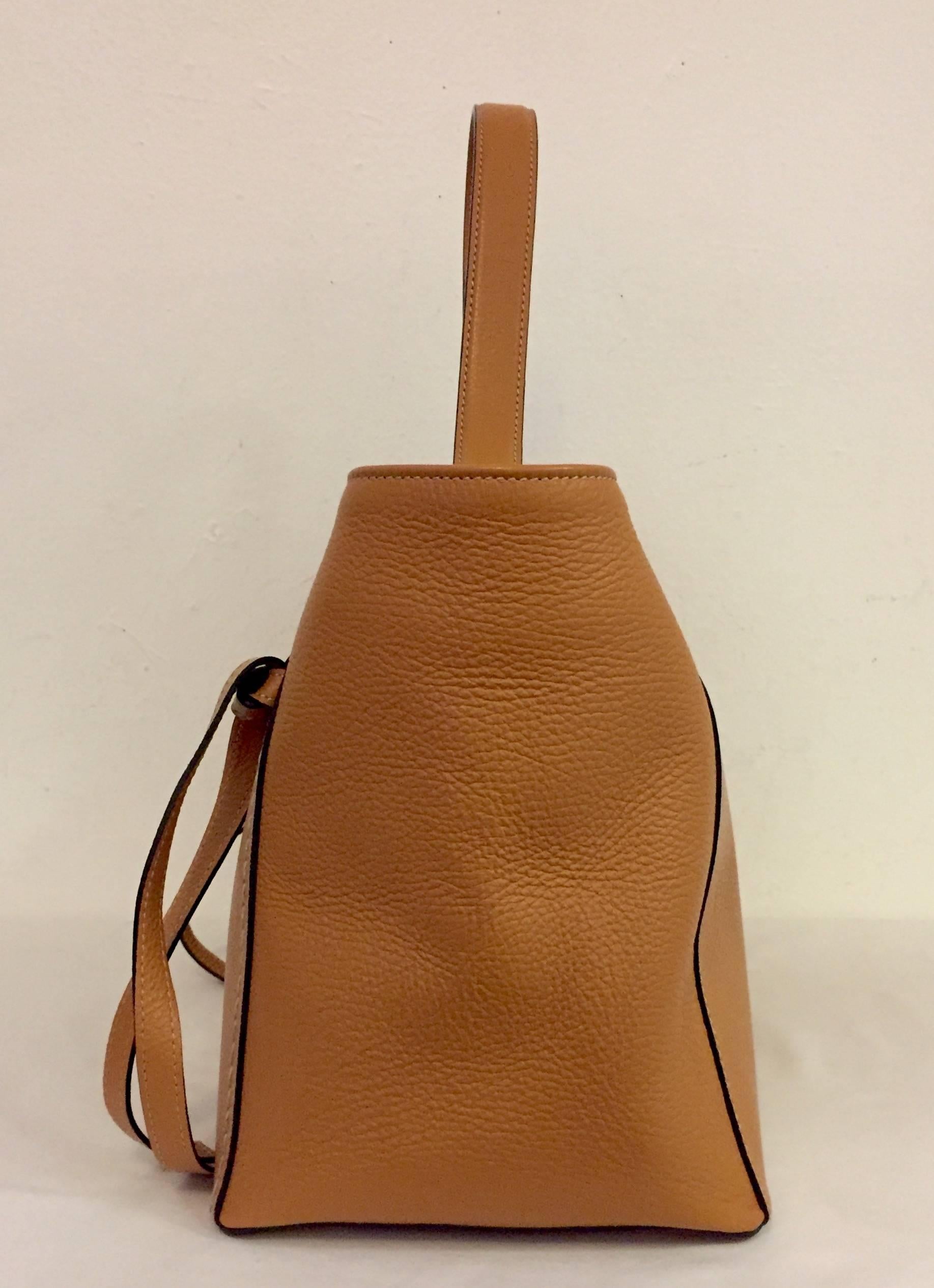 This new Valentino by Mario Valentino grain leather Camilla bag is outstanding!  It can be used as a handbag or shoulder bag.  Two knotted straps adorn the front of the bag as well as the Valentino, Milano plaque.  The rose colored hardware and