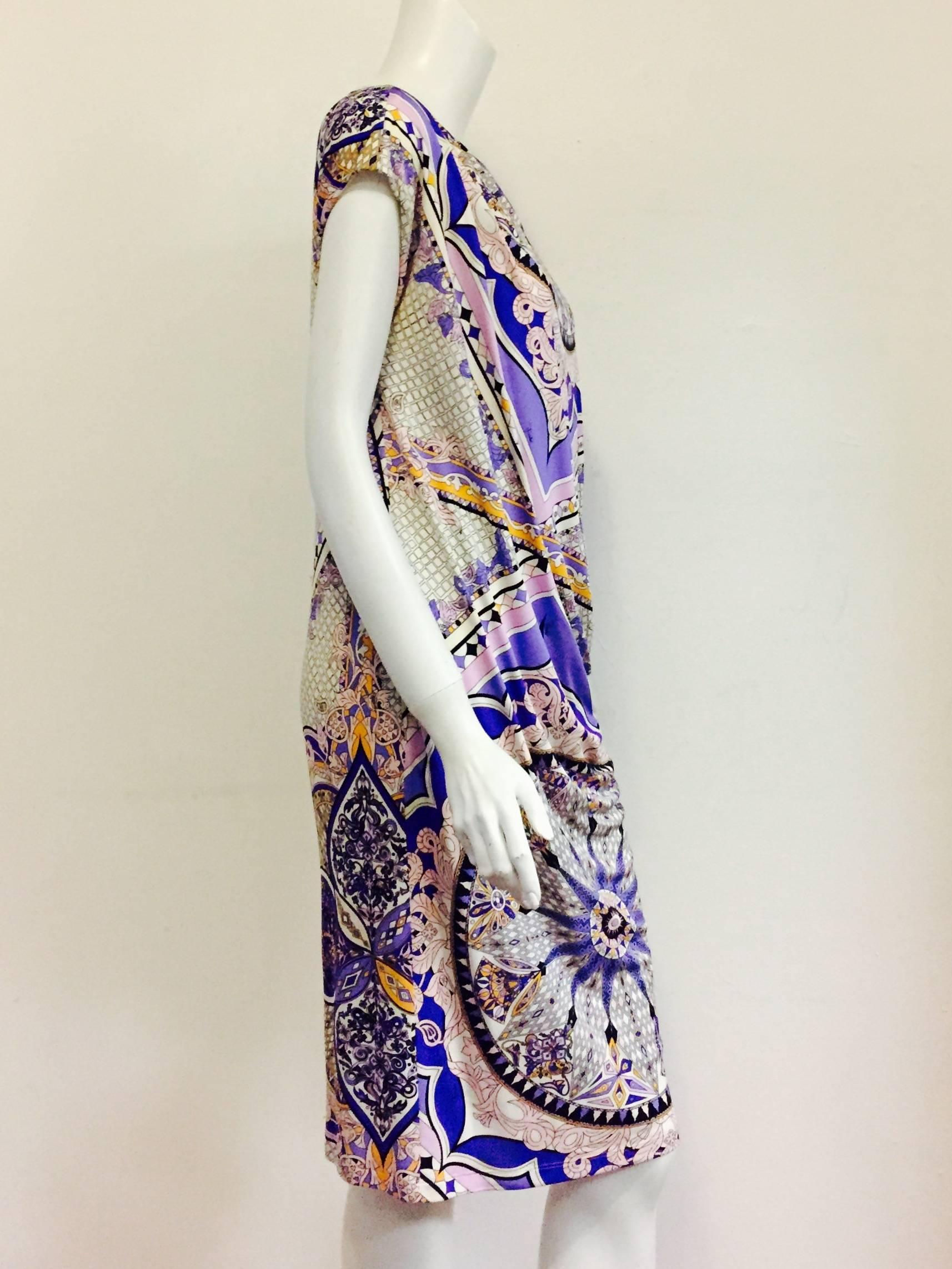 Print Sheath Dress with scoop neck is quintessentially Emilio Pucci!  Features signature abstract circle design in lavender, purple, pink, black and white with orange highlights for a flattering design. Reminiscent of the 1920s, dress is draped and