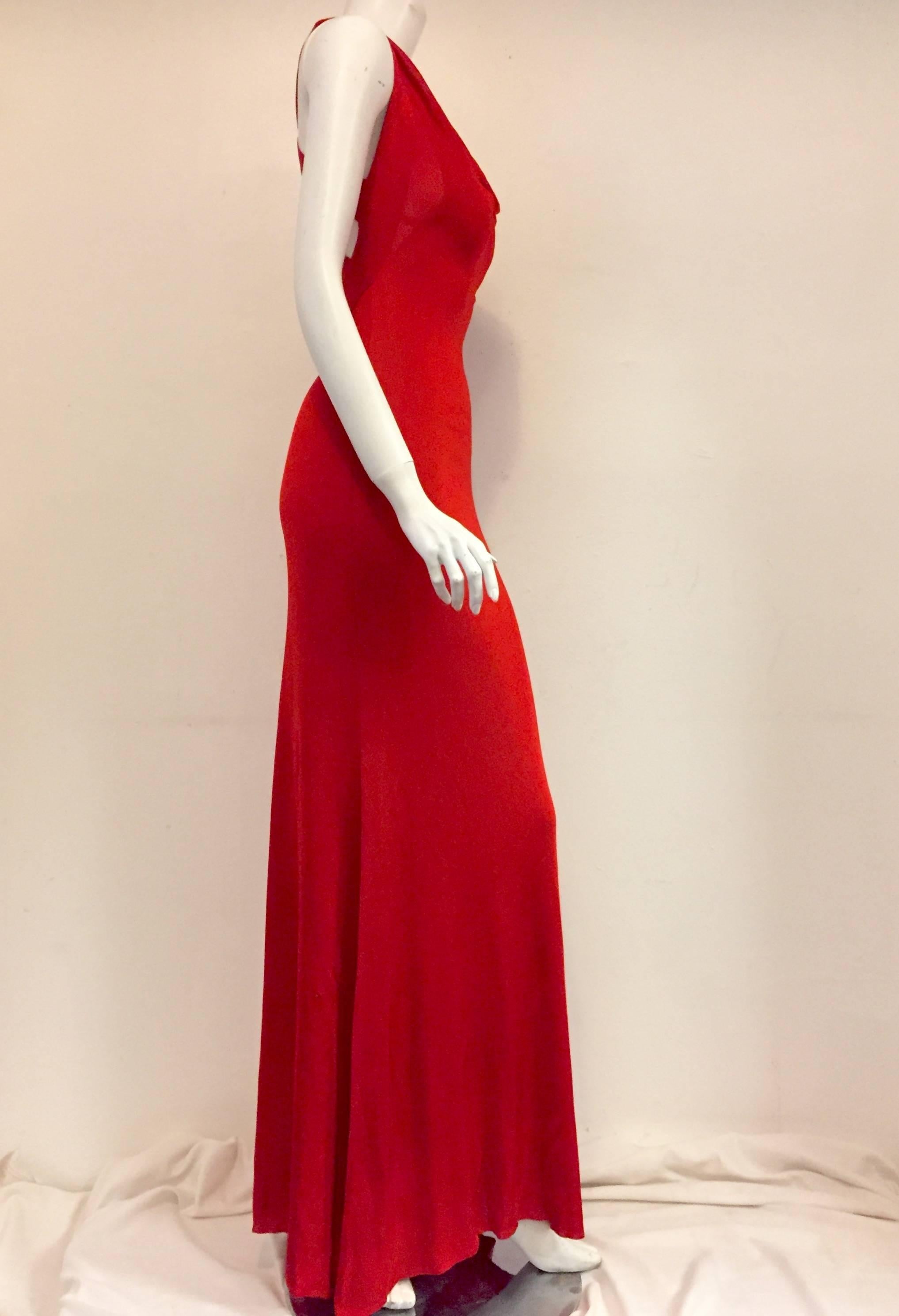 Fit for a siren, this striking Red Alexander McQueen gown features crisscross straps on back and scalloped neck in front. Crafted from luxurious 100% viscose this gown celebrates the natural curves of a woman and promises an unforgettable,