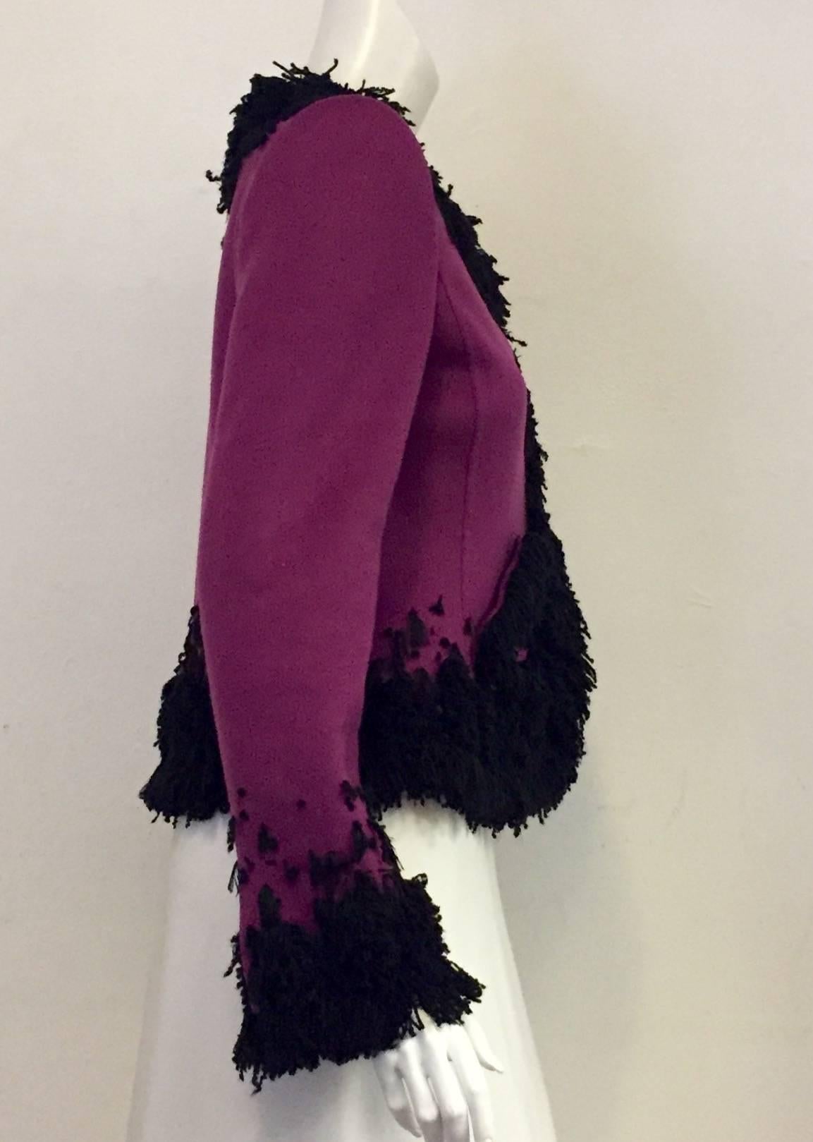 Oscar de la Renta's Violet cashmere jacket with long sleeves and split cuff is traditional and chic.  Features boucle details in contrasting black around the collar, hem and sleeves.  Offset, five-snap front closure gives this glamorous garment a