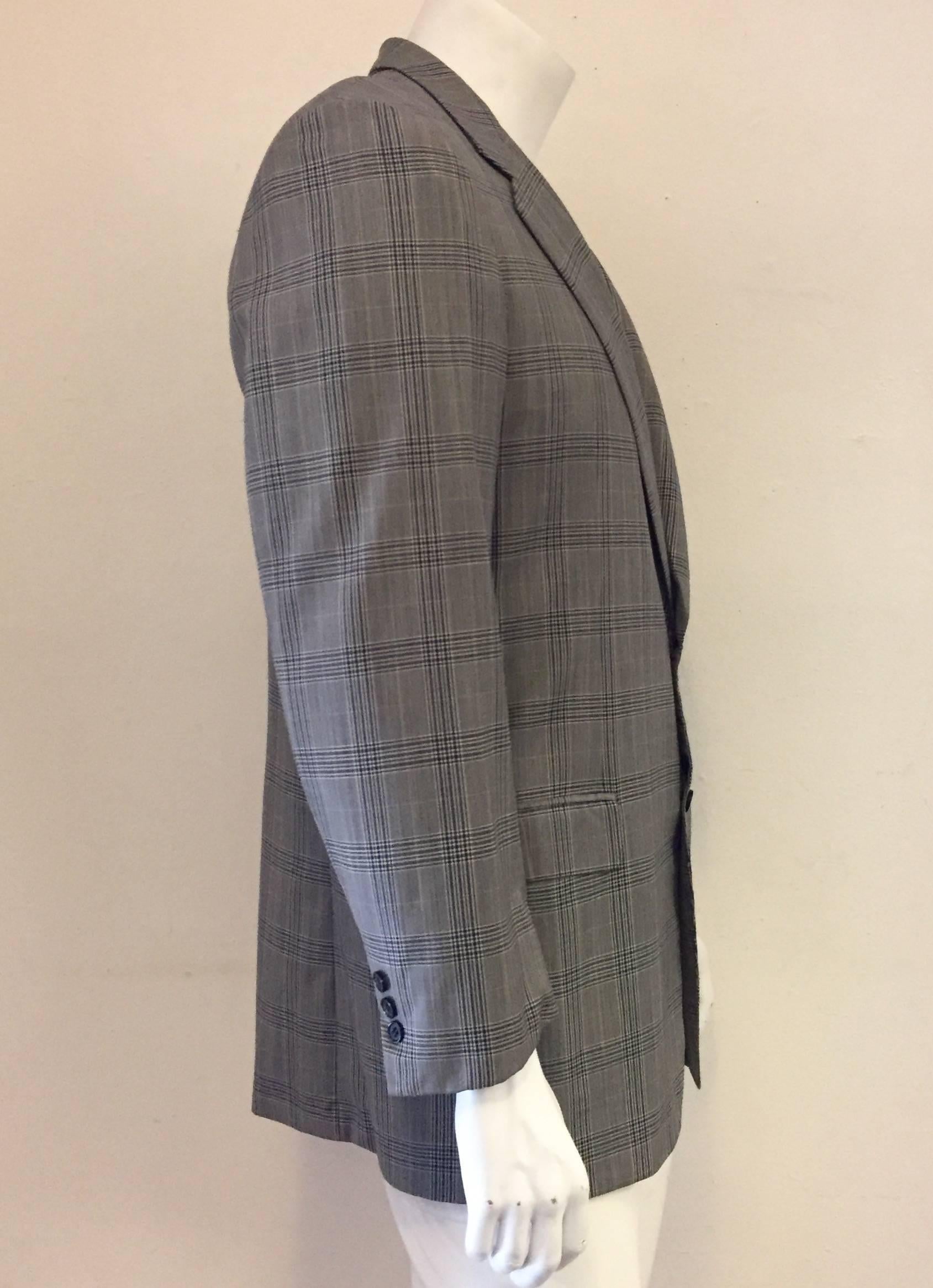 This jacket has notched lapels and two-button front closure.  Elegantly assembled with 2 flap pockets and a chest welt pocket.  Single vent back in a windowpane check 100% Wool cloth.  This sport coat bears the heritage of the Brioni House