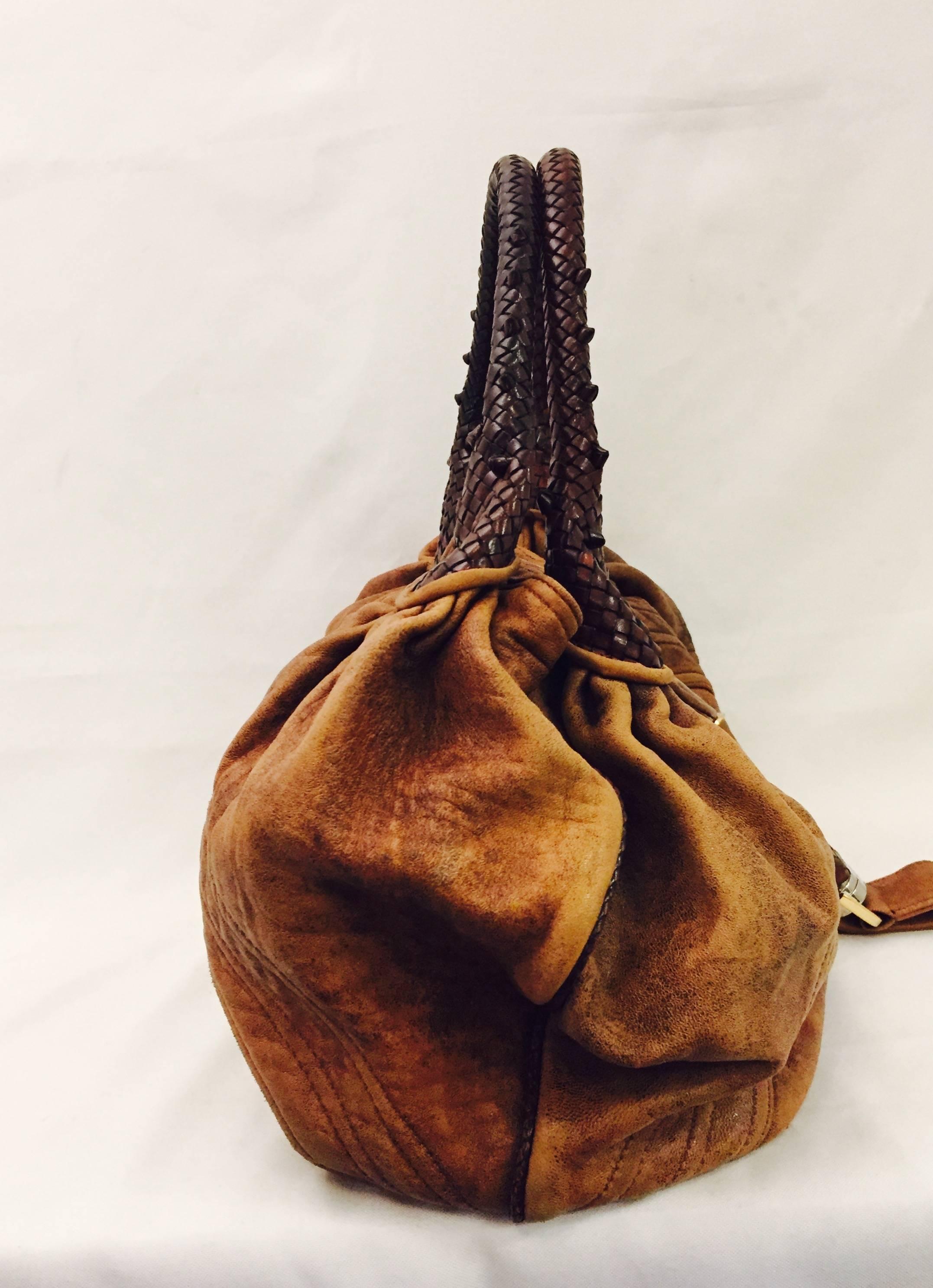 This authentic Fendi Spy Hobo Bag is iconic and timeless. With beautiful craftsmanship and incredible woven detail on the handles, this bag is a collectible. The dark brown woven top handles gives a true richness and luxury to this Spy Hobo handbag.