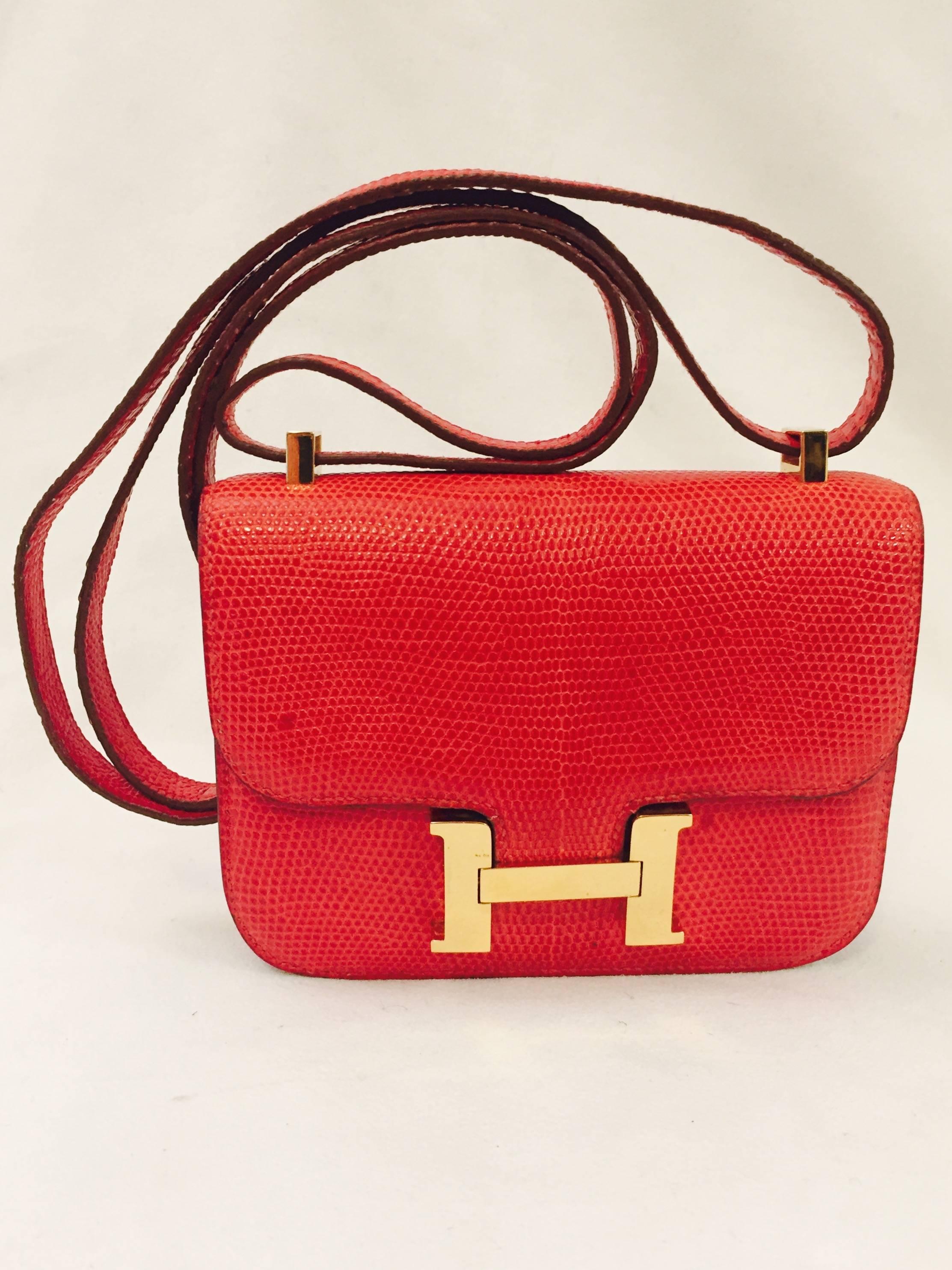 This Hermes Constance micro bag was designed by Catherine Chaillet, who named this bag after her daughter.  It has now become one of Hermes' most loved bags.  This red lizard micro is simply elegant with the gold H emblem in the middle for closure. 