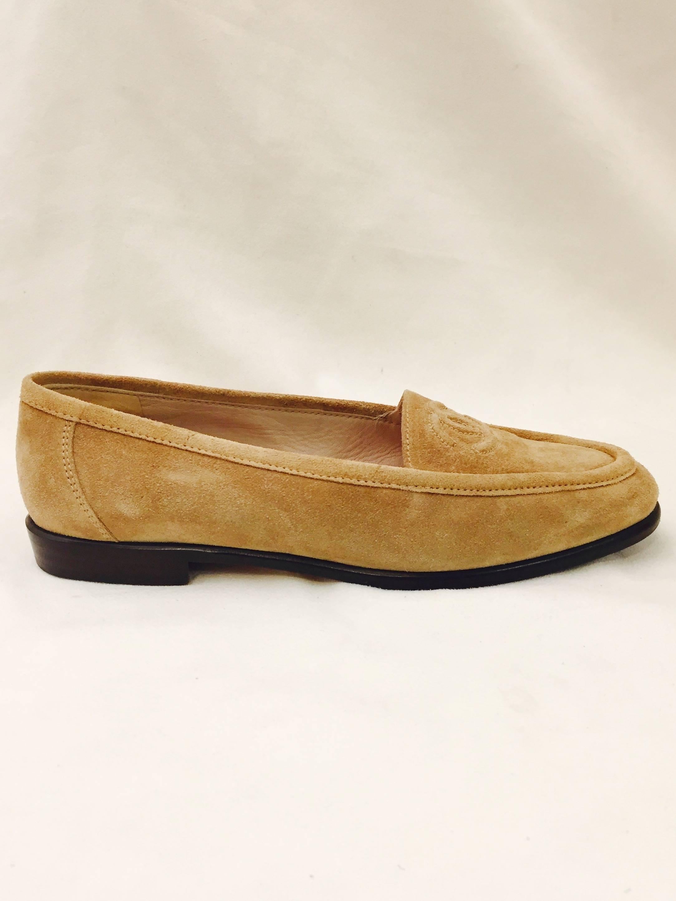 Distinctive and casual Chanel beige suede loafers with embossed CC logo on vamp are a must for all lovers of 