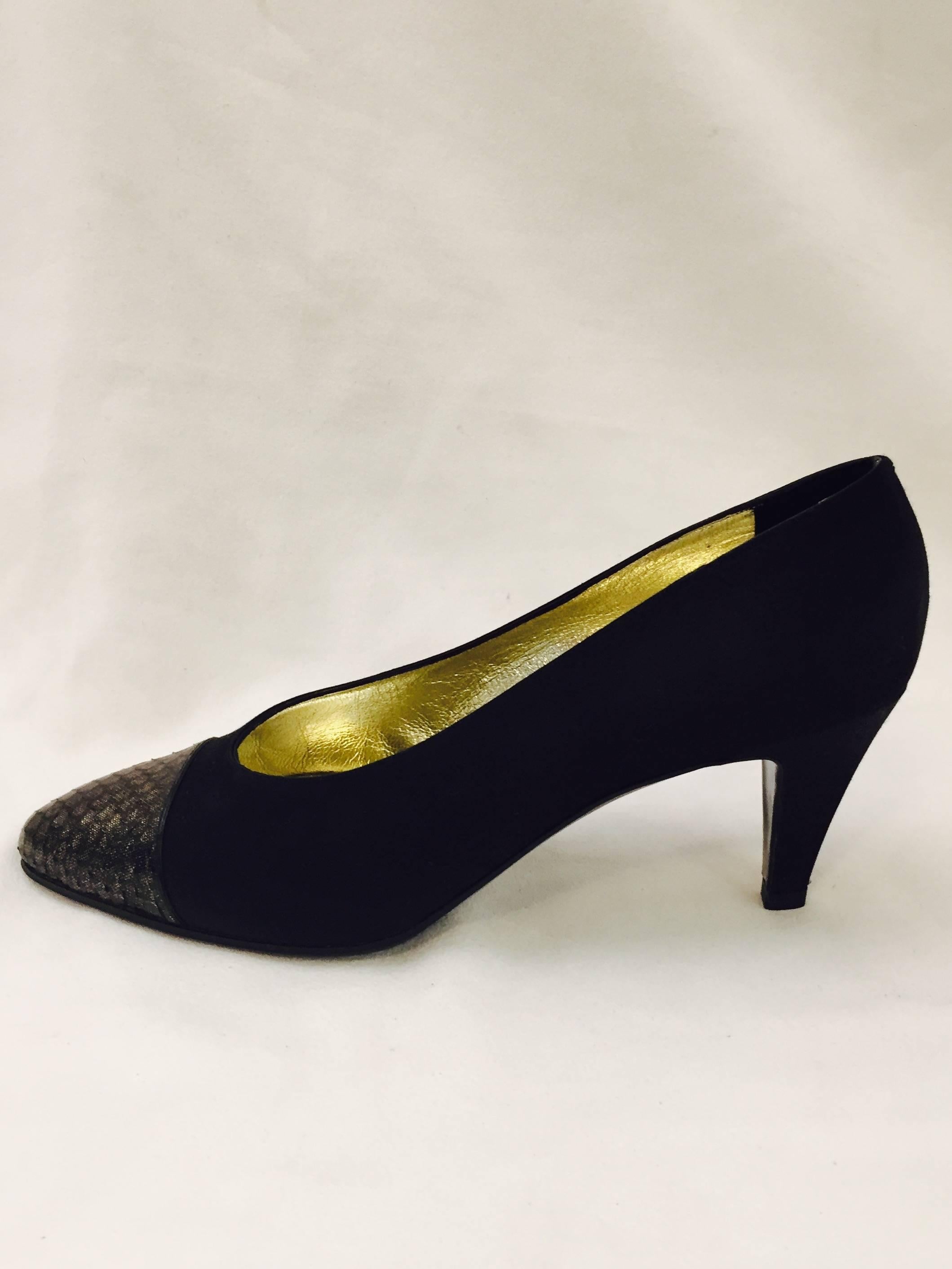 These Chanel satin pumps are made for dancing!  Embellished in gold and black on cap toes, these are lined in gold tone leather.   The heel is 2.5