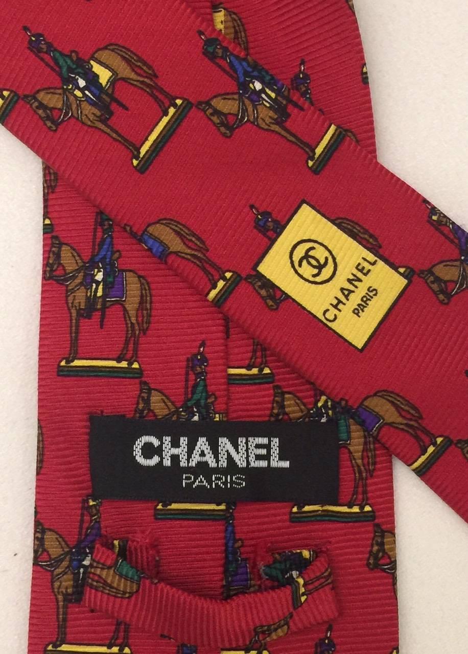 Fabulous Chanel tie featuring elite mounted grenadiers.  A wonderful item for the collector and Chanel aficionado. Rich red background.  3.5 inch width.