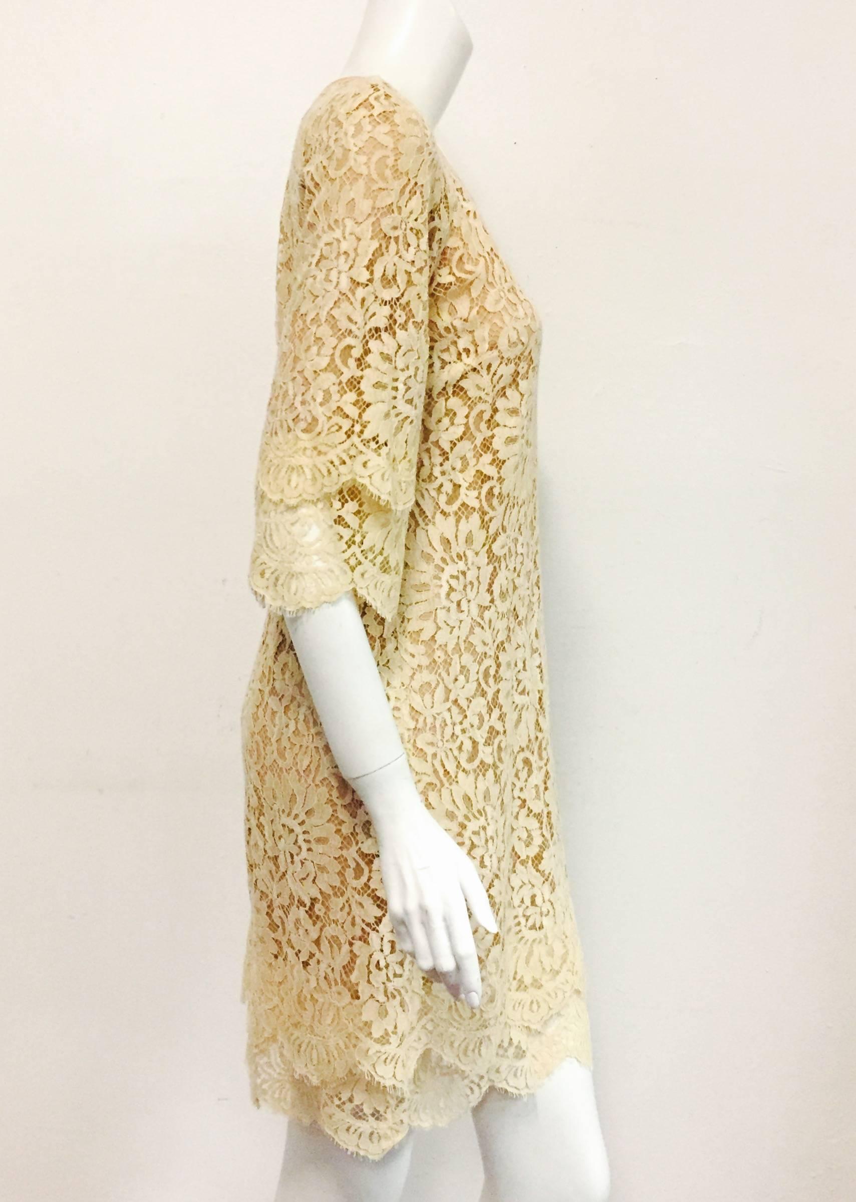 Made in Italy, this Michael Kors Beige Lace dress has a silk border around the scoop neckline and three-quarter raglan sleeves.  Optional silk ribbon may be used to cinch this ode to femininity at the waist for a more tailored look.  The 3/4 sleeves