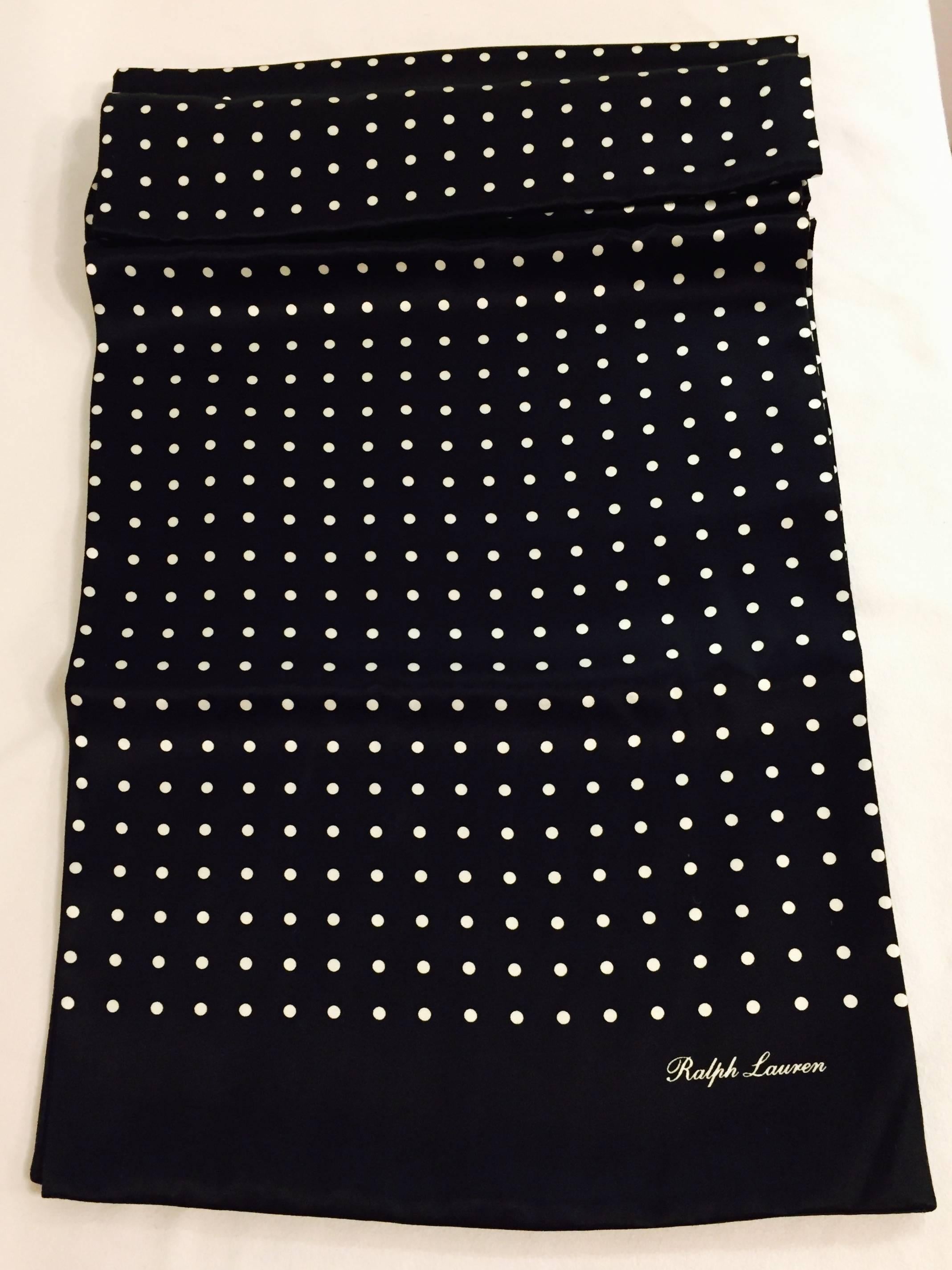 Cut a dashing figure in your tux, with this refined Ralph Lauren scarf in two sided silk, with ivory polka dots on a black background.  Made in Italy, it measures 12 inches wide and 62 inches long.
