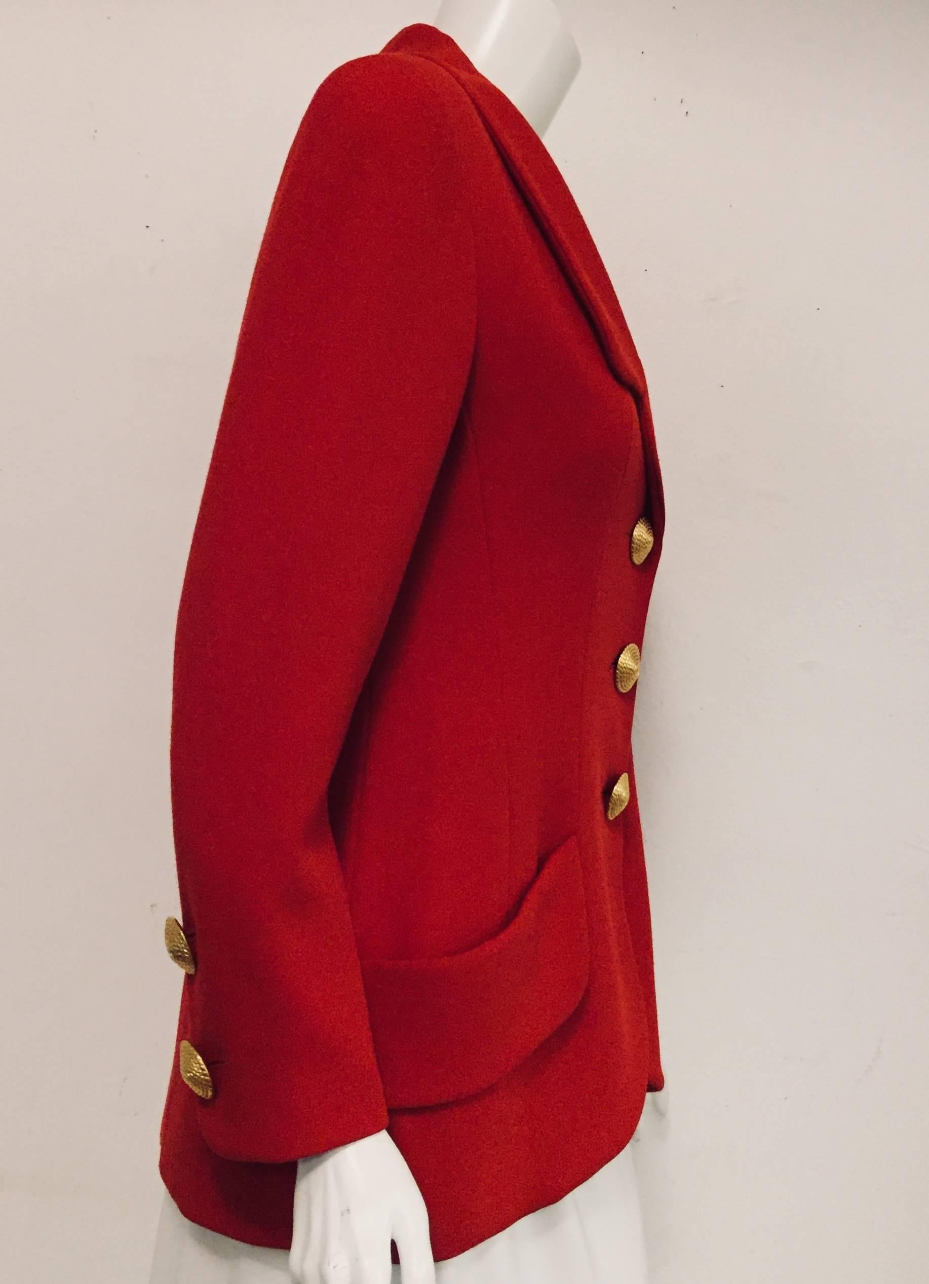 Chanel brilliant red wool jacket with 3 large gold tone logo buttons at front for closure is a fantastic addition to your Chanel wardrobe. You will also find 2 of the same buttons at the cuff of the sleeves and one smaller button on the lapel, a